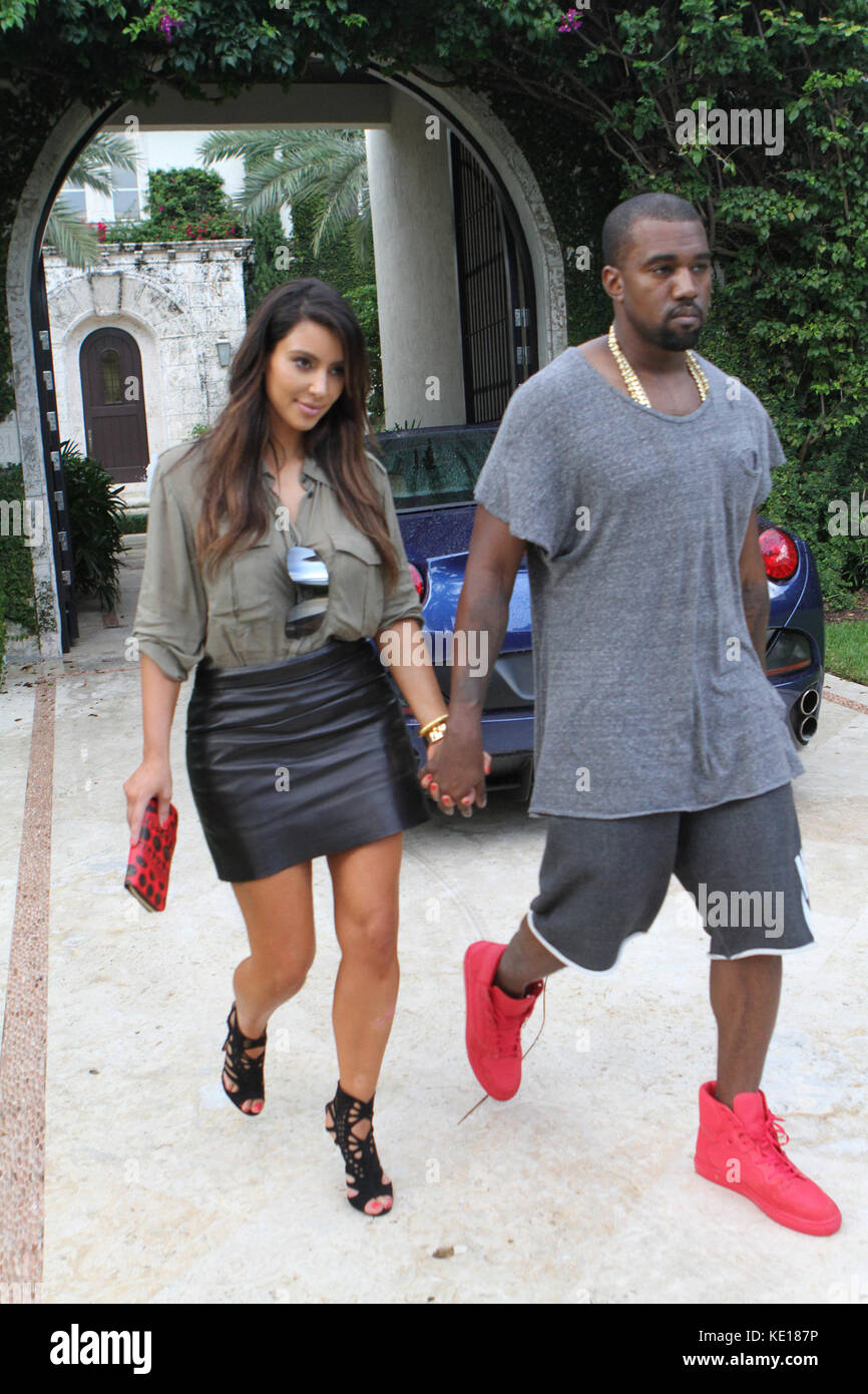 MIAMI, FL - OCTOBER 08:  Kim Kardashian is said to be devastated that her ex, Reggie Bush is expecting a baby with his girlfriend, Lilit Avagyan She was seen today walking in the rain hand and hand in Miami house hunting with boyfriend Kanye West . on October 8, 2012 in Miami, Florida.  People:  Kim Kardashian Kanye West  Transmission Ref:  MNC4   Credit: Hoo-Me.com/MediaPunch Stock Photo