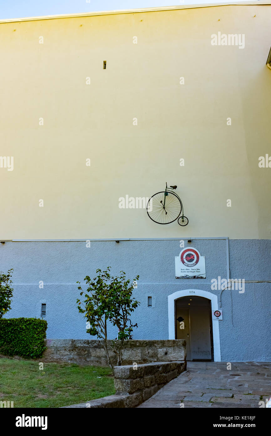 Penny Farthing bike on wall Stock Photo
