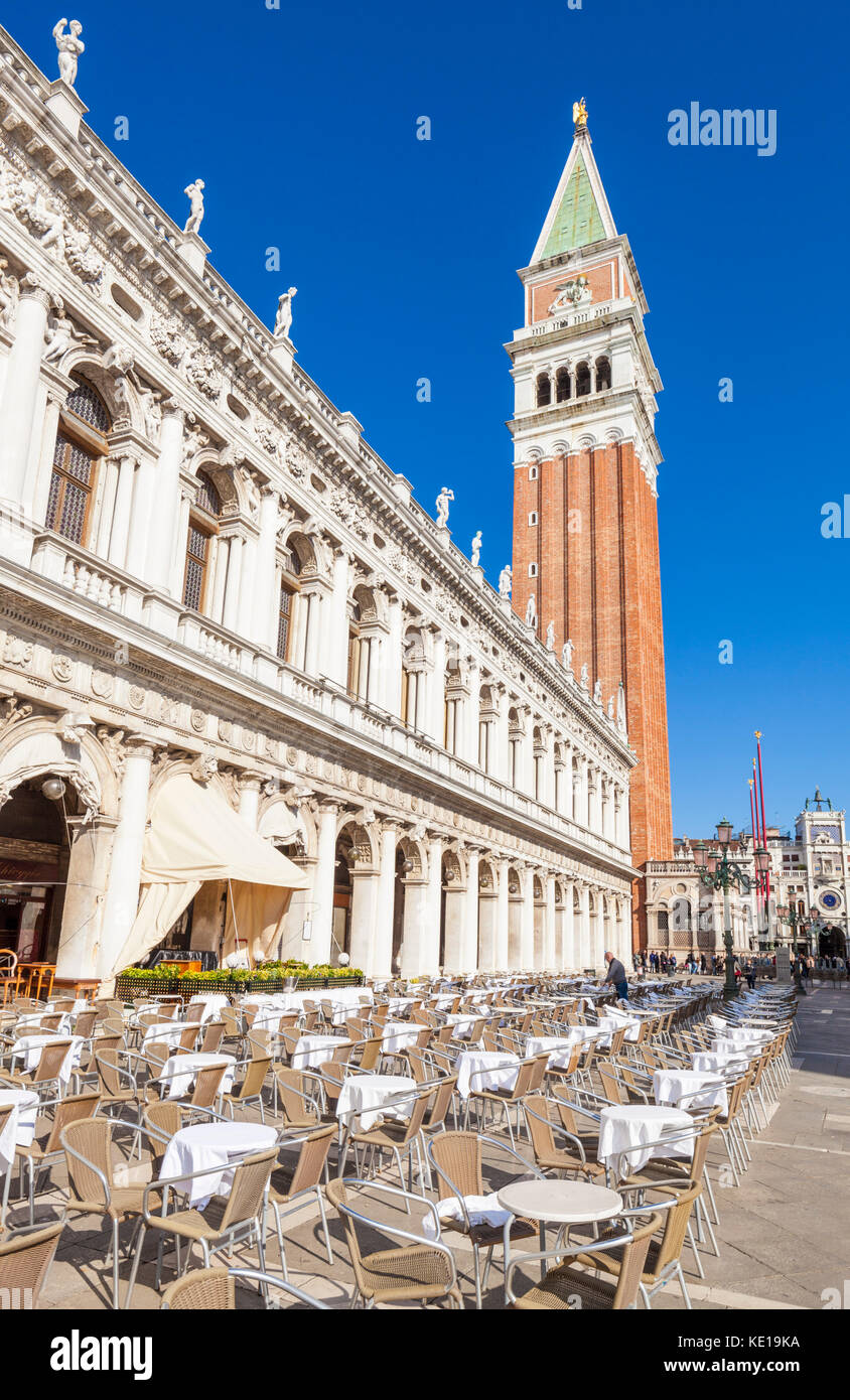 VENICE ITALY VENICE  Empty chairs and tables at a cafe restaurant St Marks square Piazza san marco with the campanile Venice Italy EU Europe Stock Photo