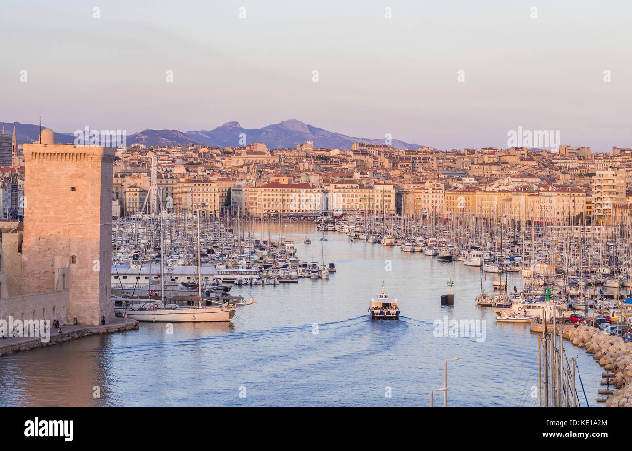 MARSEILLE, FRANCE - AUGUST 07, 2017: The old Vieux Port of Marseille beneath Cathedral of Notre Dame, France, at sunset. Stock Photo