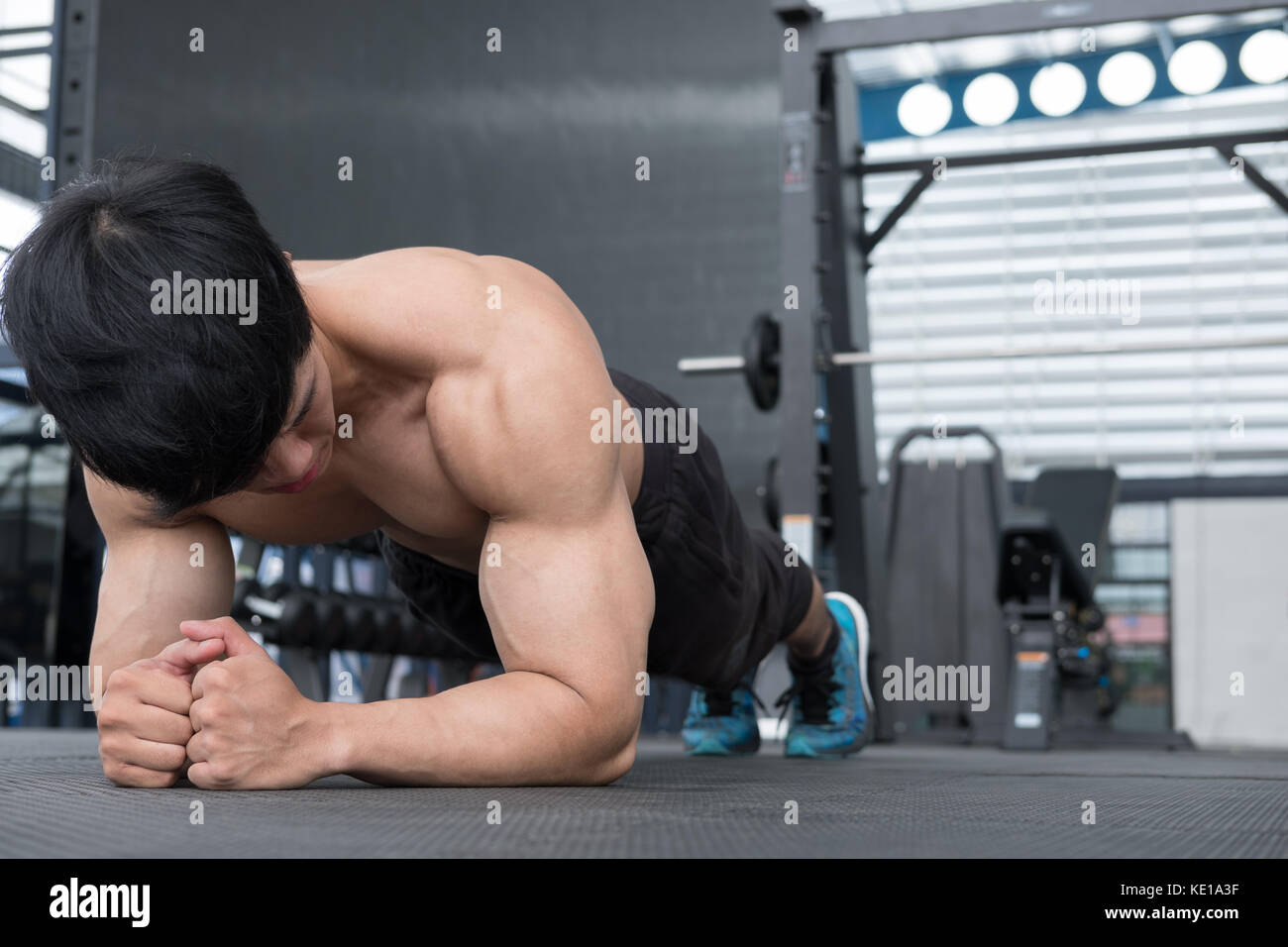 young muscle man doing plank position in gym. bodybuilder male working ...