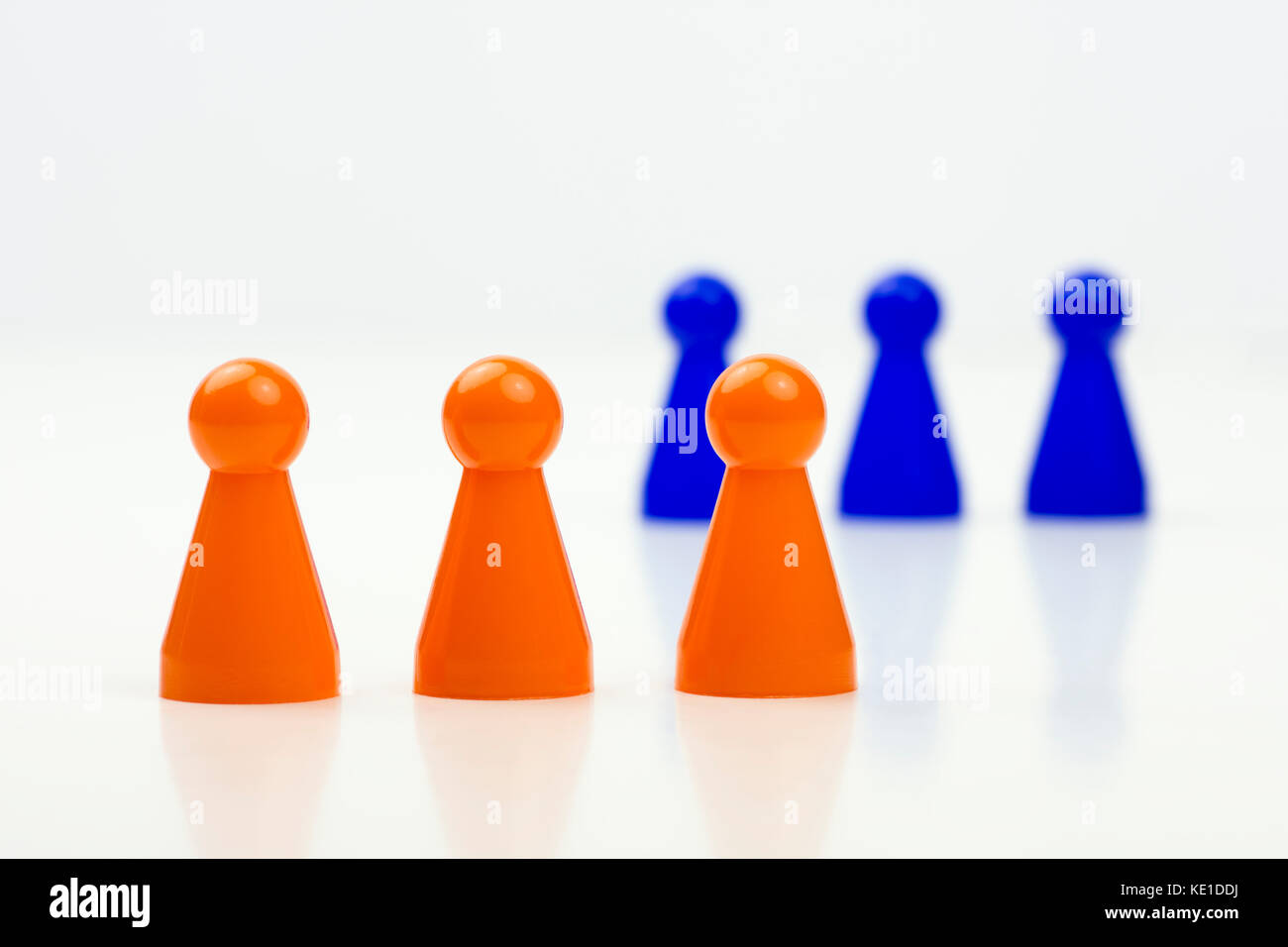 Close-up photo of a group of different-colored pieces in different positions on a white background - applicable to the team view Stock Photo