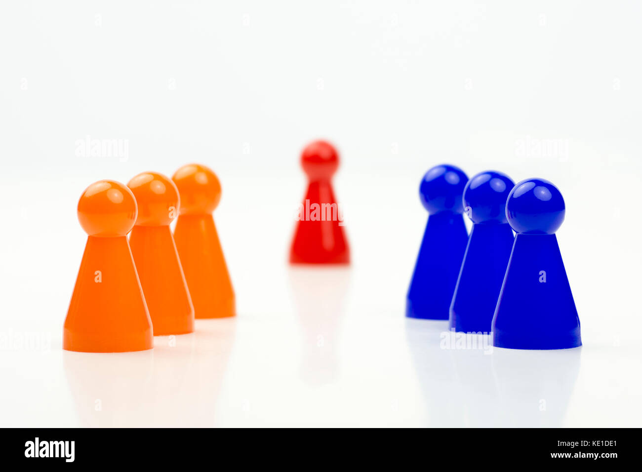 Close-up photo of a group of different-colored pieces in different positions on a white background - applicable to the team view Stock Photo