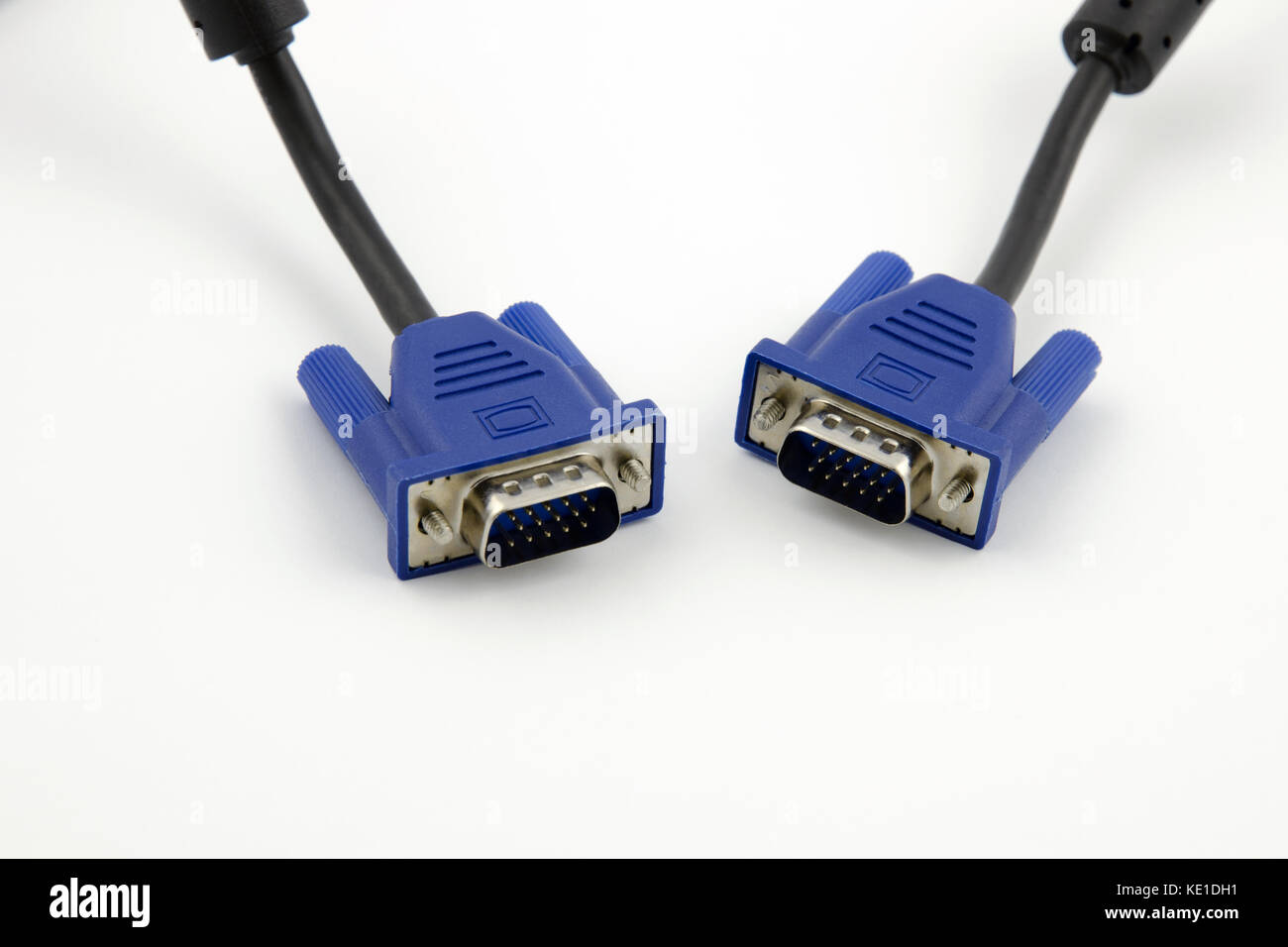 Detailed view of two VGA video connectors with black cables on a white background Stock Photo