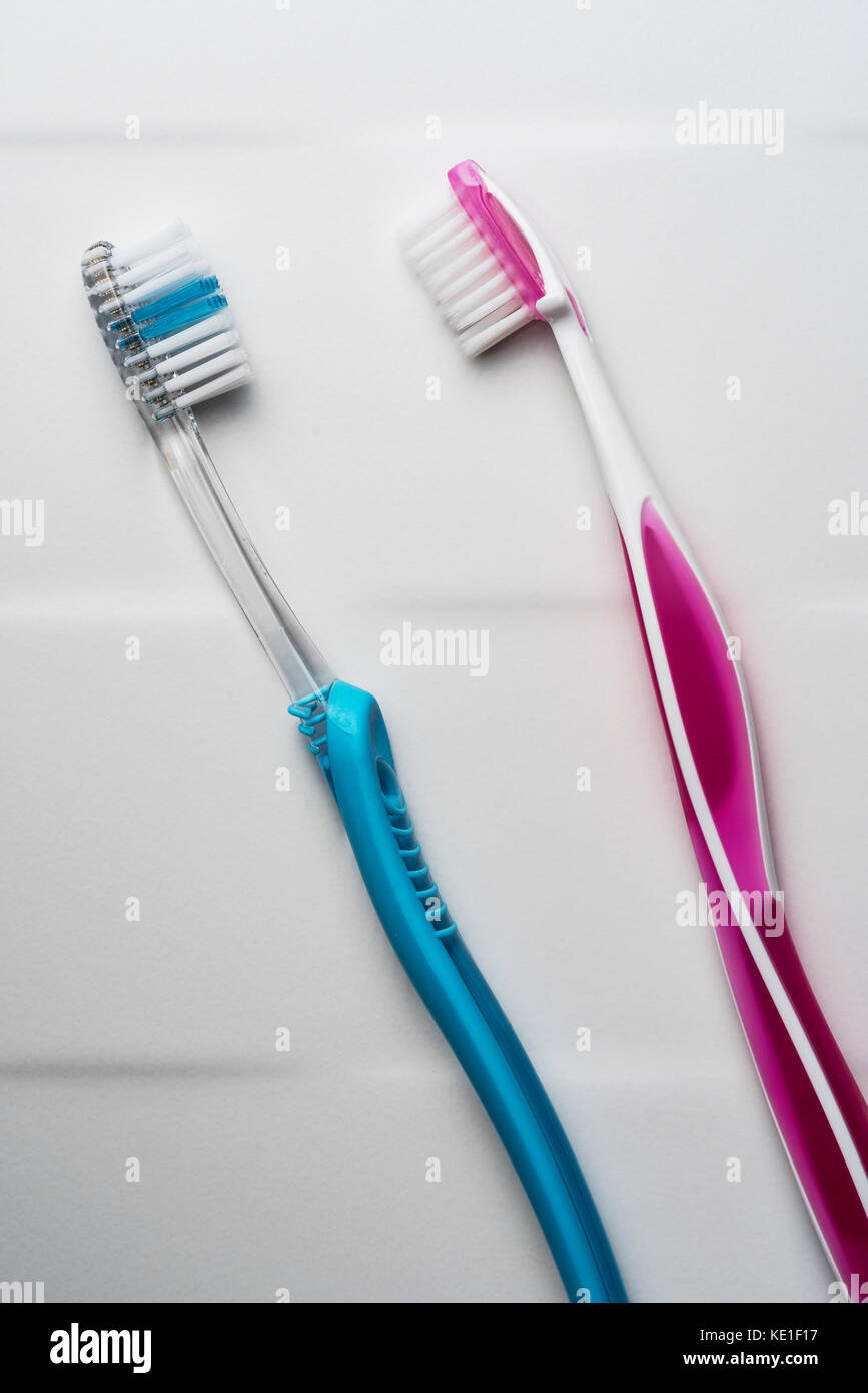 His and hers pink and blue toothbrushes. Stock Photo