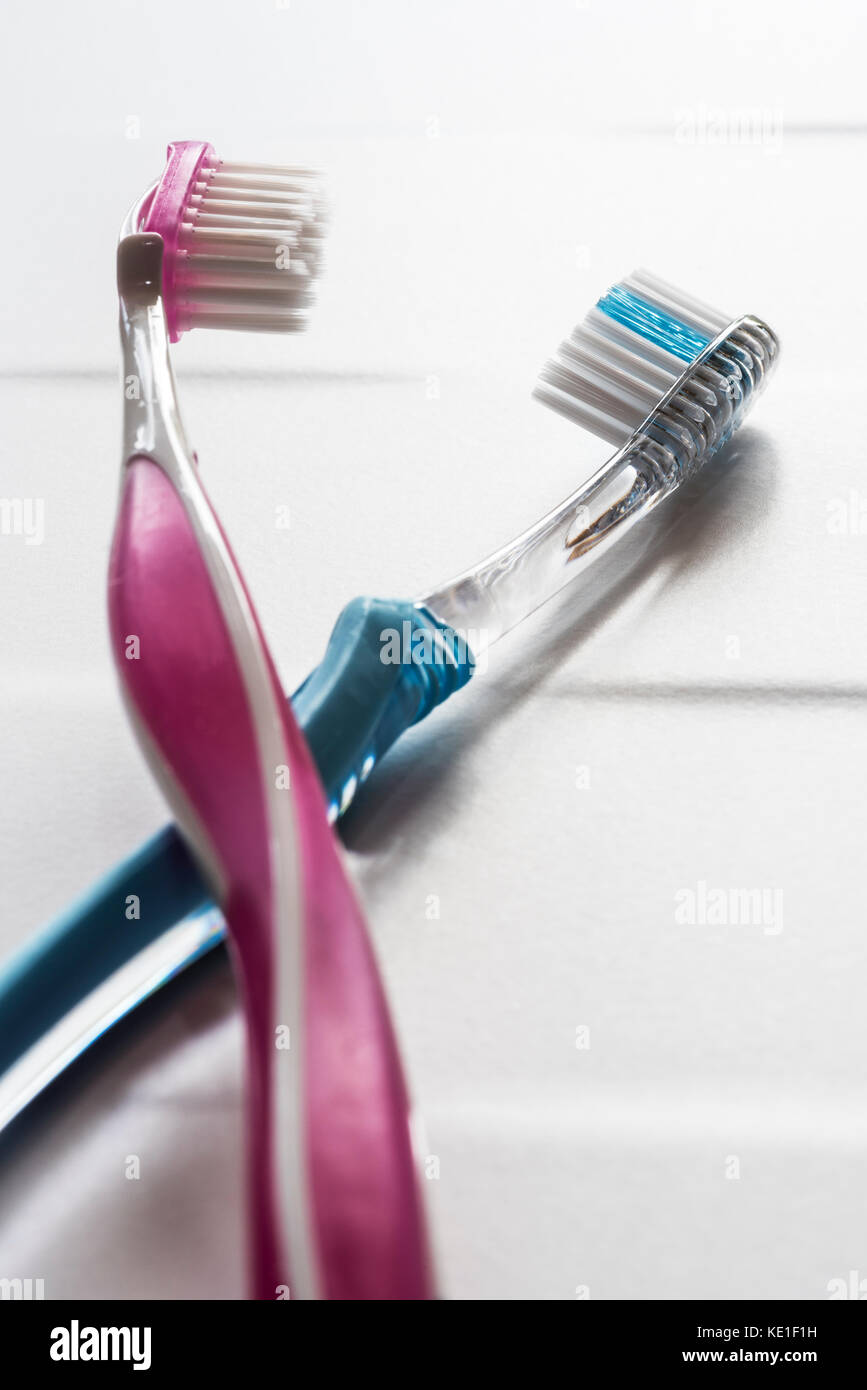 His and hers pink and blue toothbrushes. Stock Photo