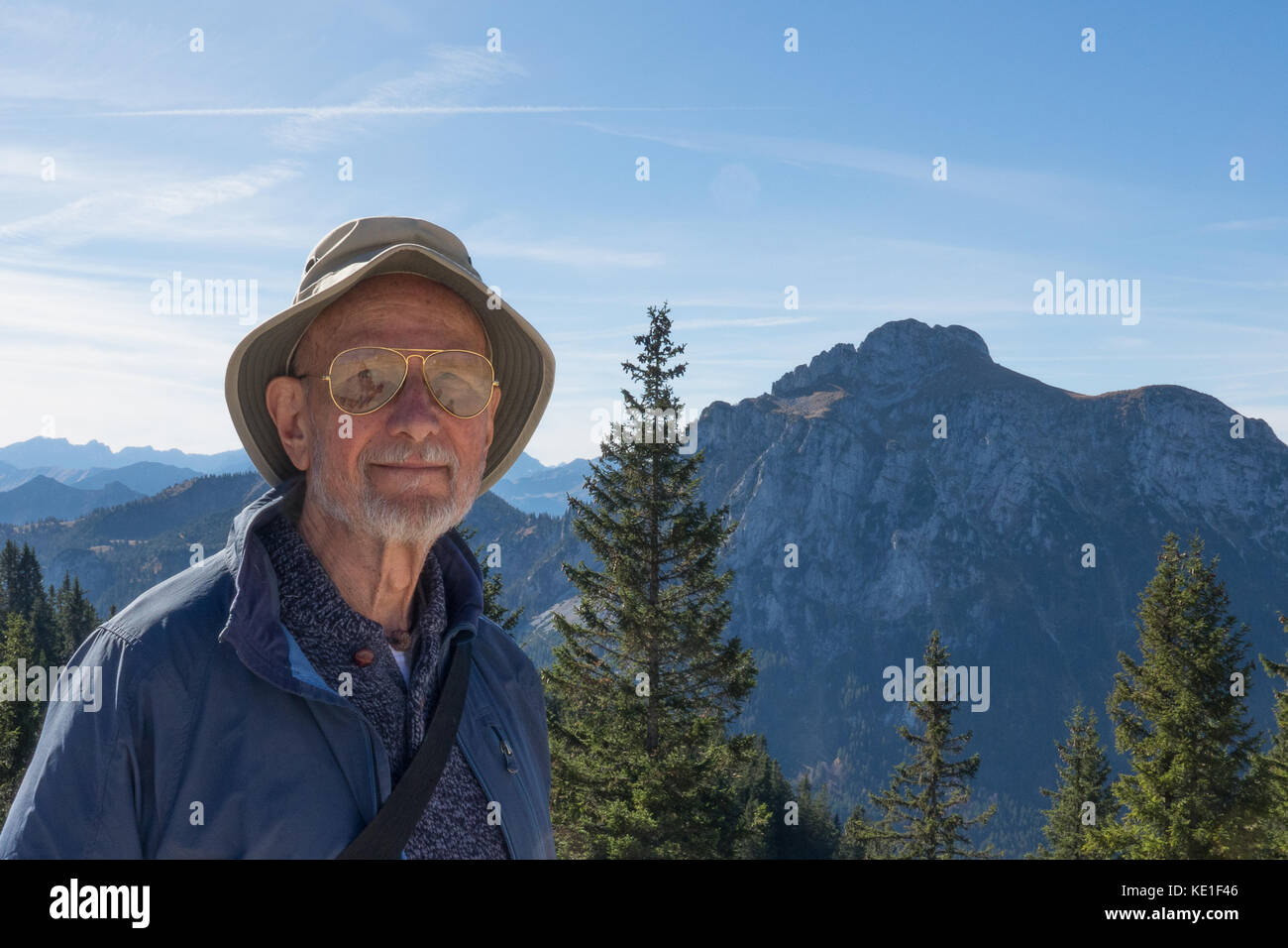 Senior man enjoying the sunny Alpen weather on Mount Tegelberg Stock Photo