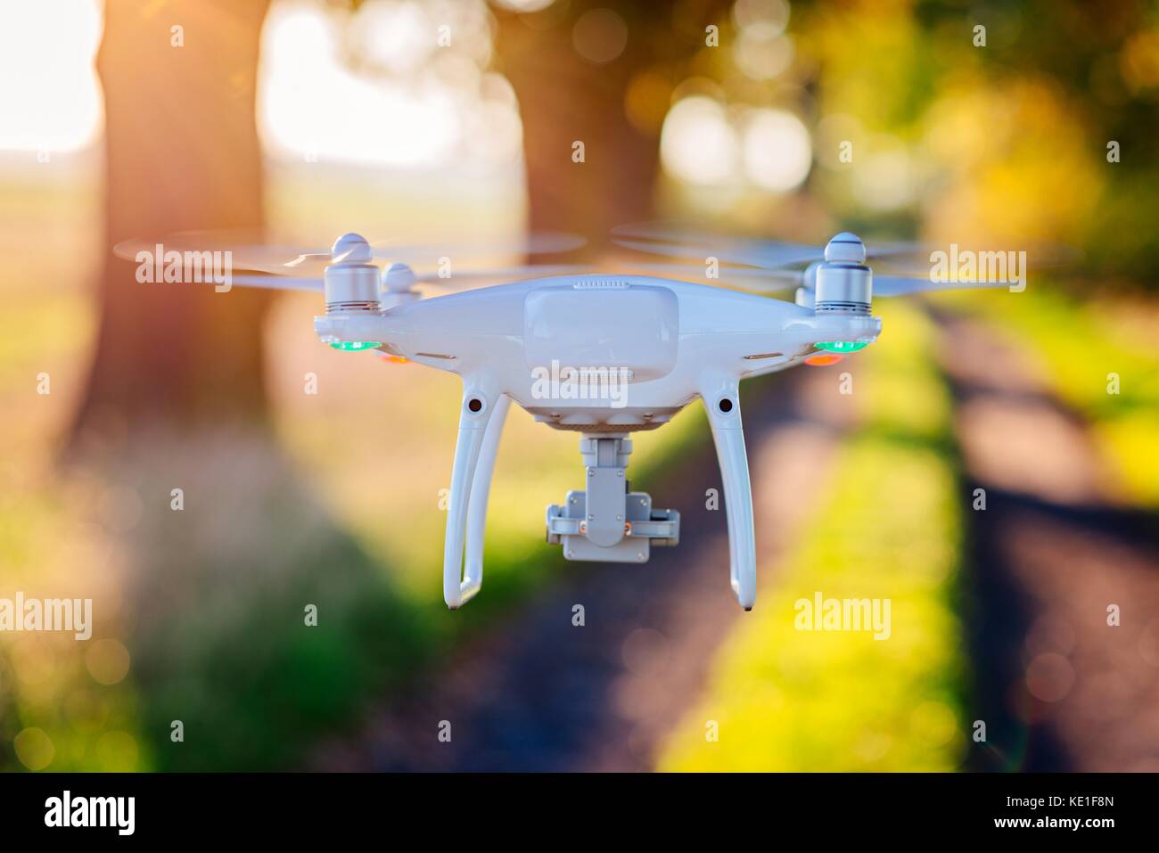 White drone quadcopter with camera in flight Stock Photo - Alamy