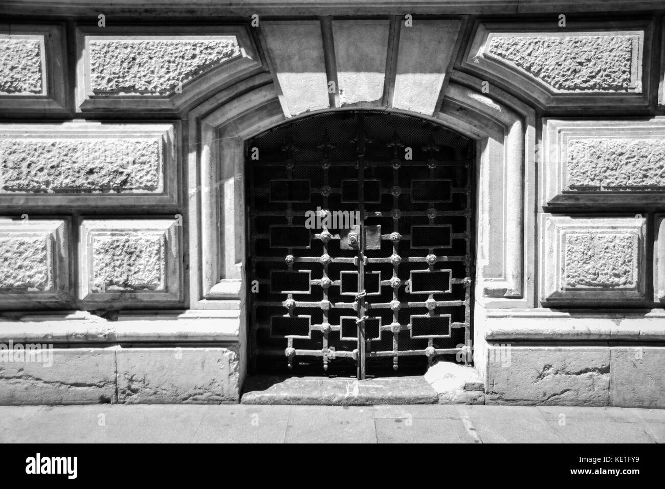 Gated open door way within a stone building Stock Photo