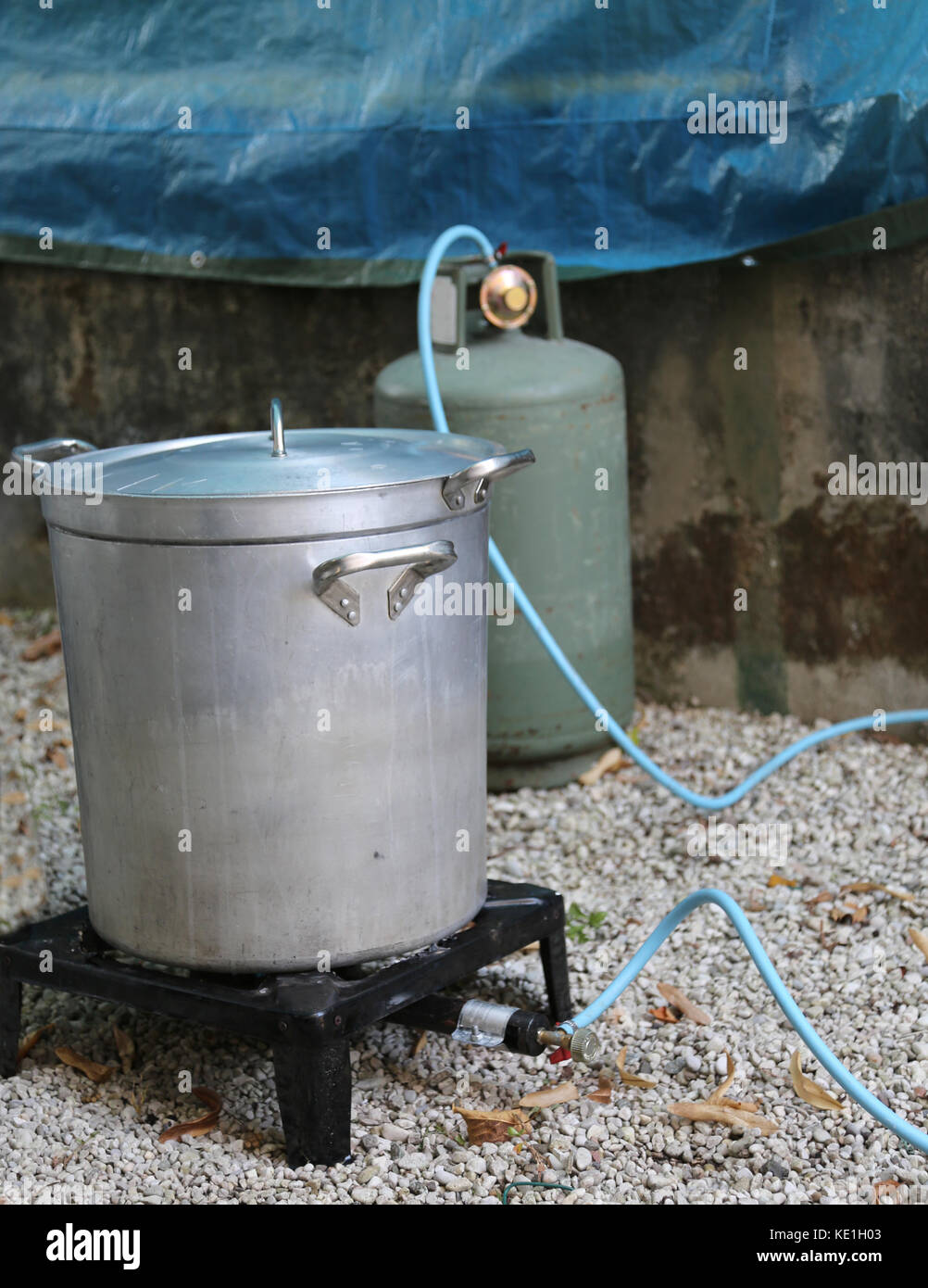 Big aluminum pot with gas canister in the camp kitchen while preparing the meal Stock Photo
