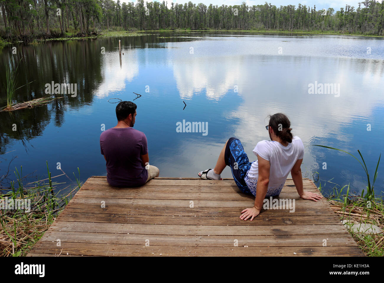 Two young man stare off at the Lake Stock Photo