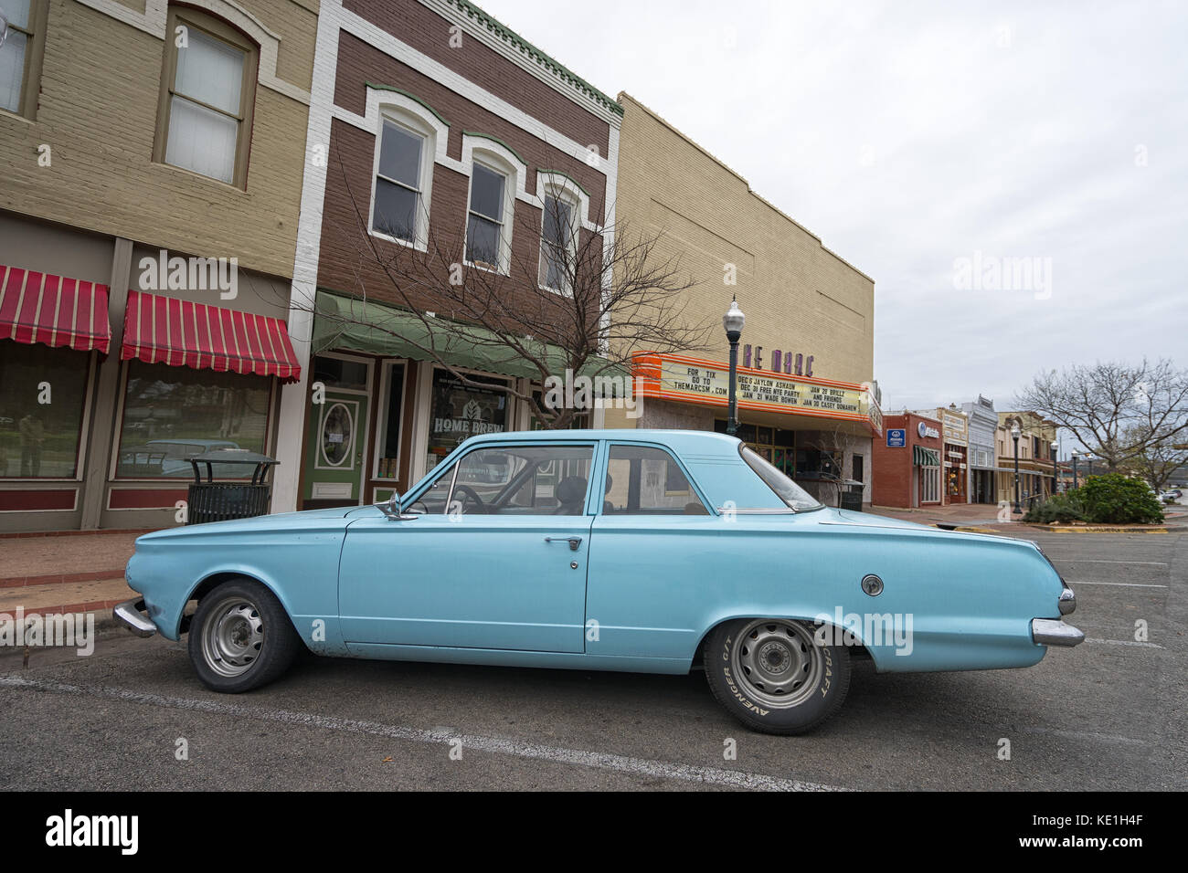 January 1, 2016 San Marcos, Texas, USA: vintage collectors car parked on the street in front of victorian buildings in the historic center of the town Stock Photo