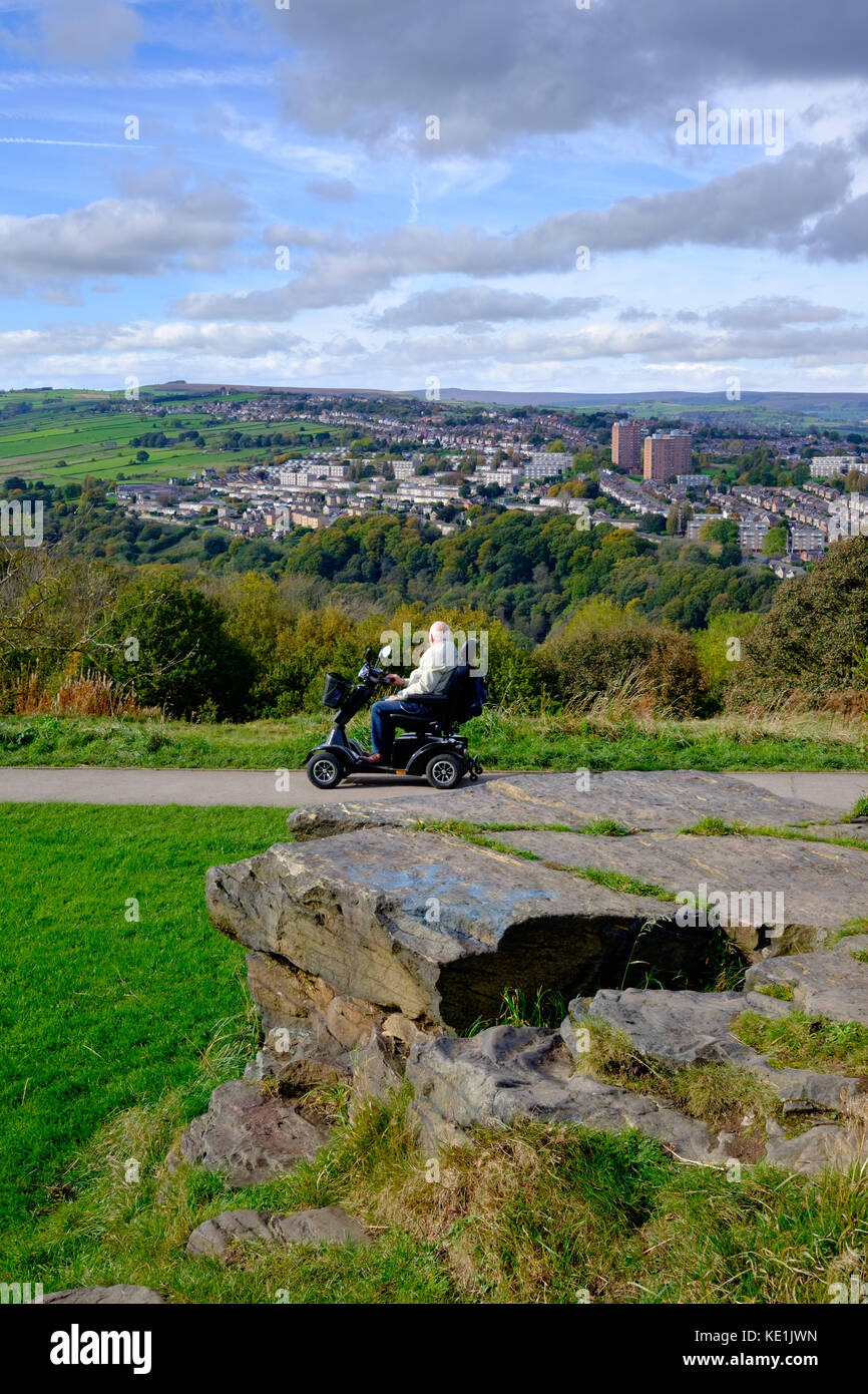 Looking over Stannington to Bradfield Moors, Peak District National Park,  from Bolehills, Sheffield, UK - man on a mobility scooter driving past Stock Photo