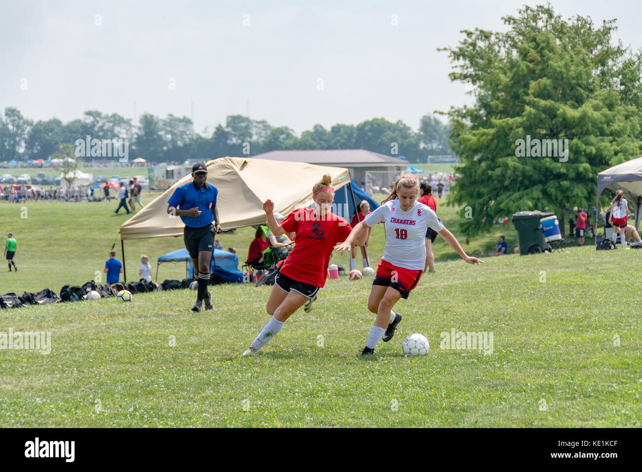 American high school teenage girls playing soccer in a game tournament Stock Photo