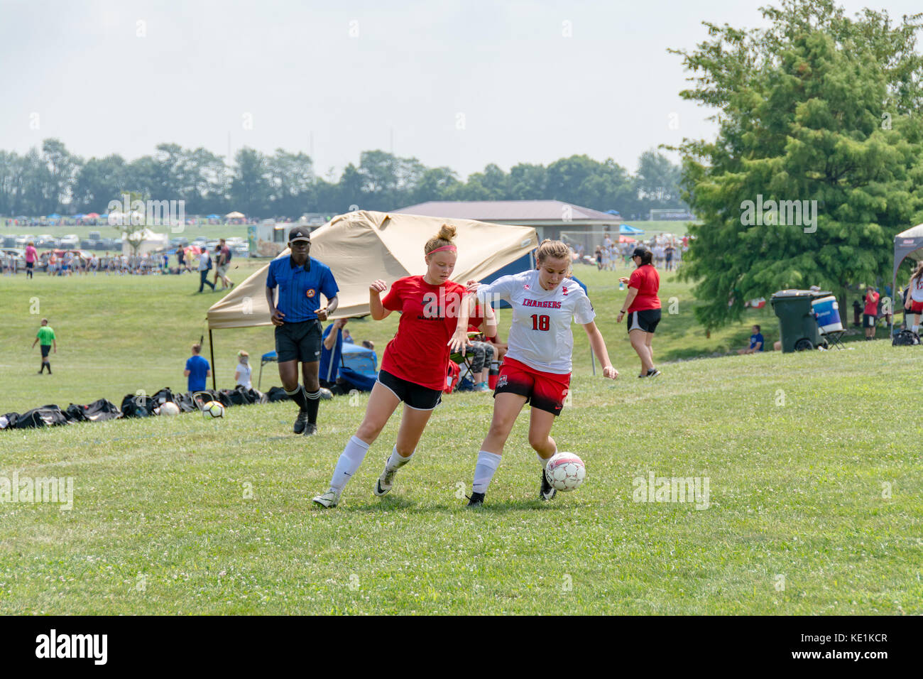 American high school teenage girls playing soccer in a game tournament Stock Photo