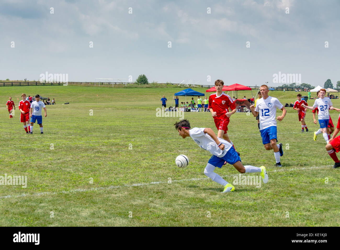 American high school teenage boys playing soccer in a game tournament Stock Photo