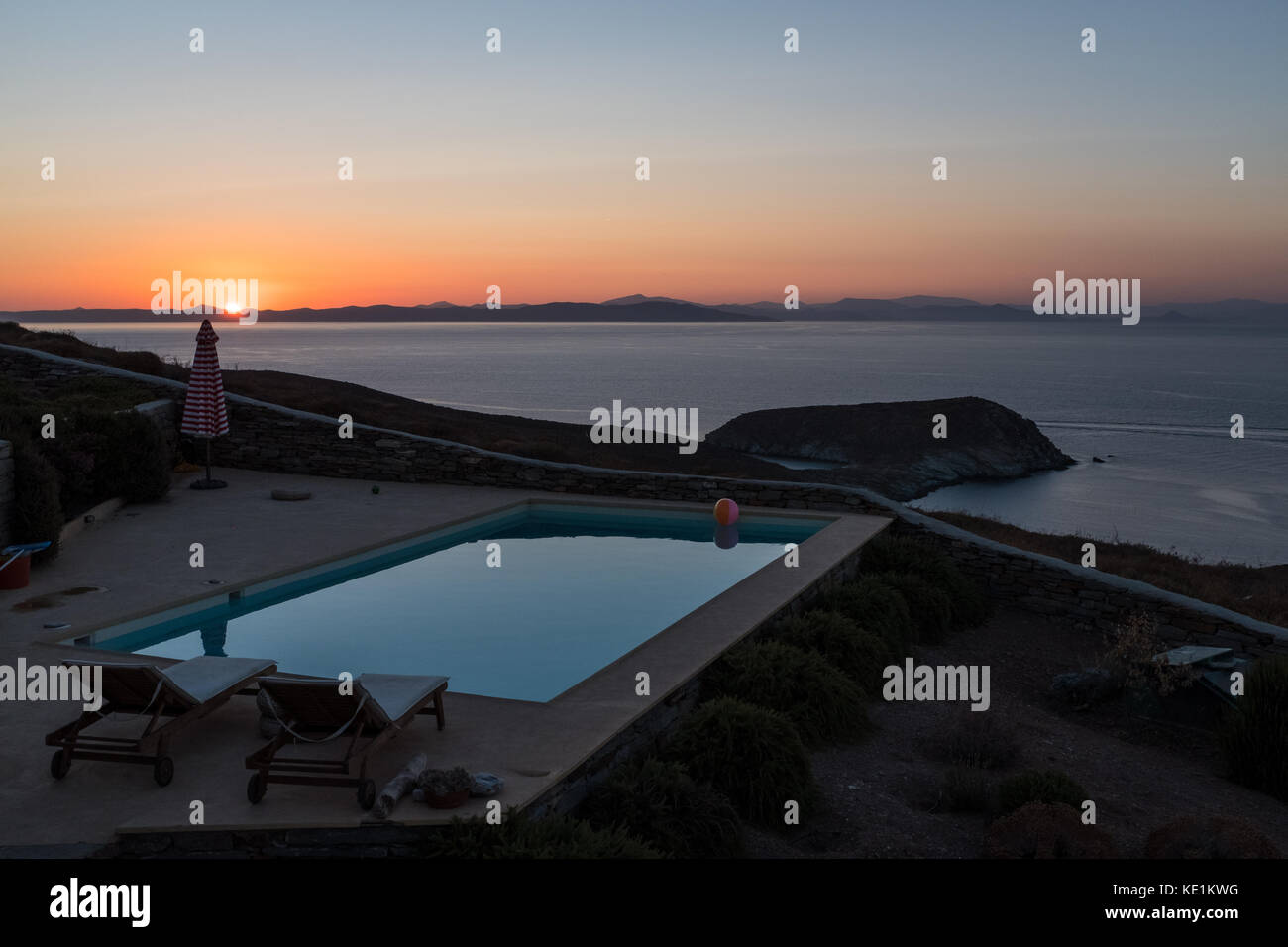 Swimming pool overlooking Aegean Sea at sunset, Kea, Grrece Stock Photo