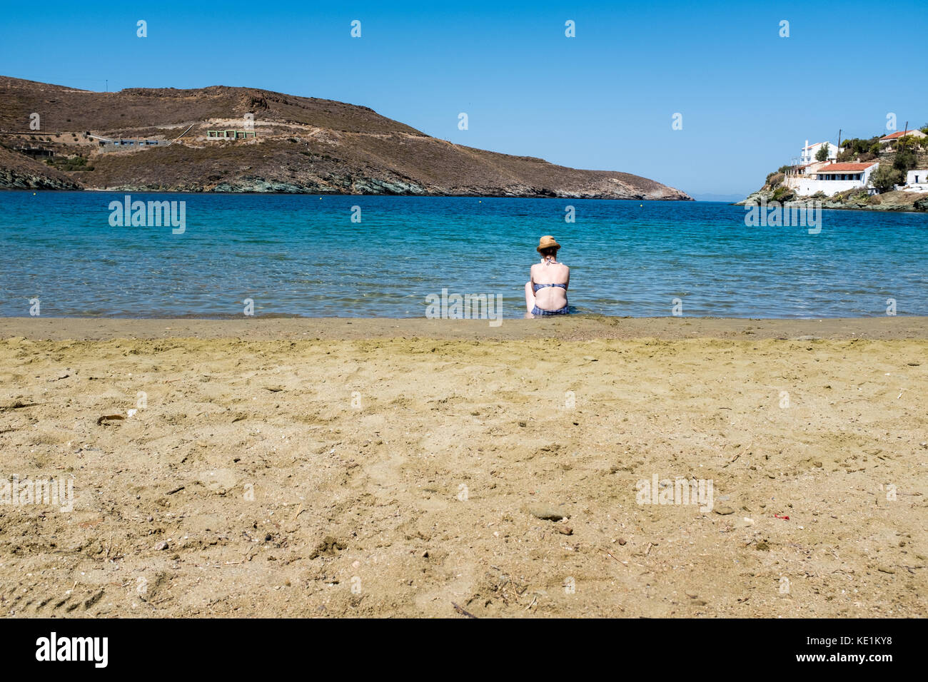 Woman reading on Otzias Beach, Kea, Greece Stock Photo