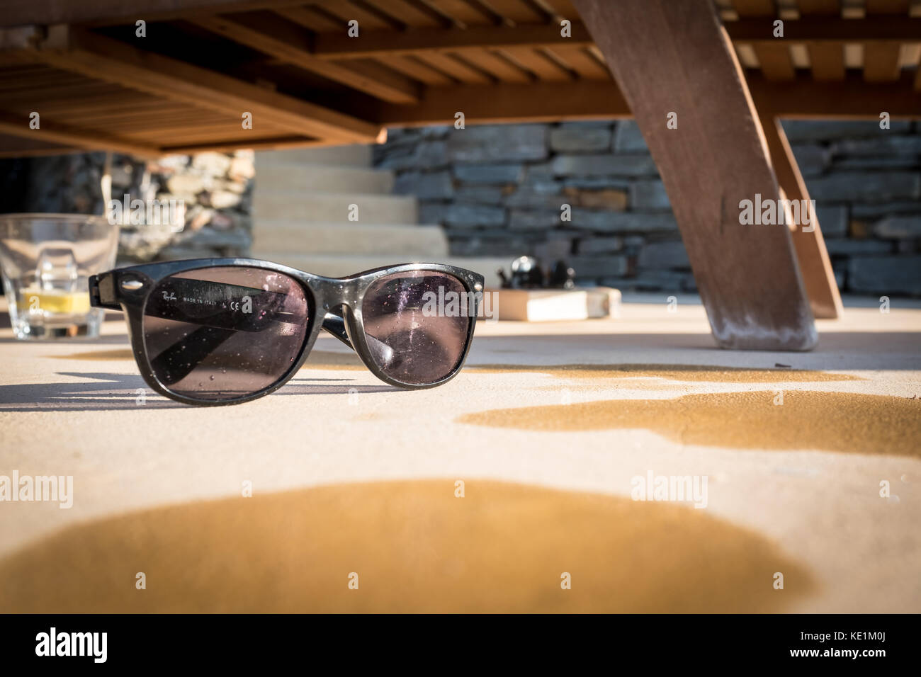 Ray-Ban sunglasses on side of swimming pool Stock Photo - Alamy