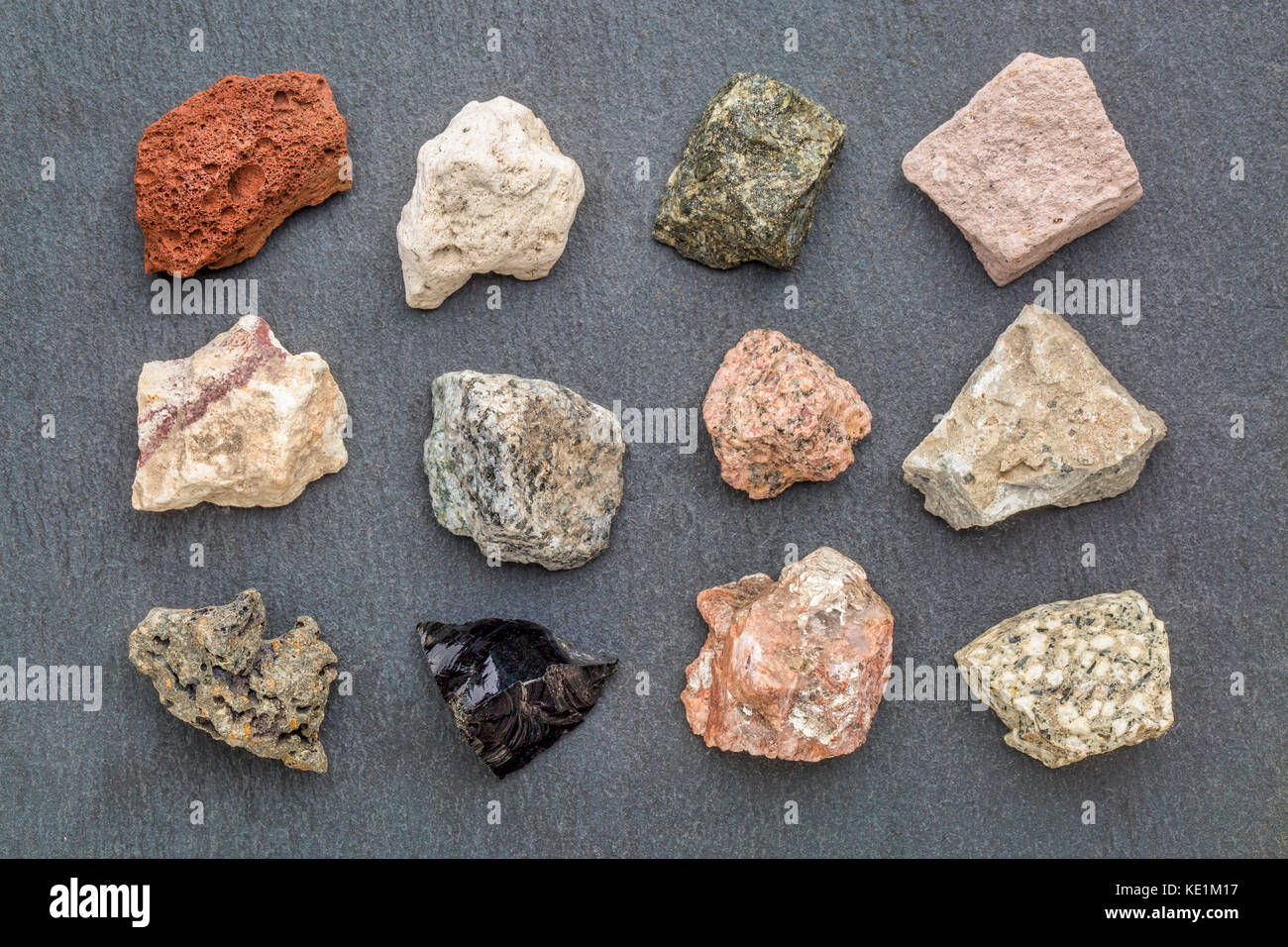 igneous rock geology collection, from top left: scoria, pumice, gabbro, tuff, rhyolite, diorite, granite, andesite, basalt, obsidian,  pegmatite, porp Stock Photo