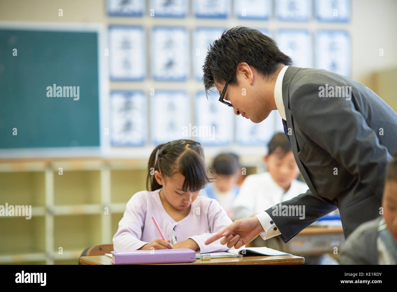 Japanese elementary school teacher teaching in the classroom Stock Photo