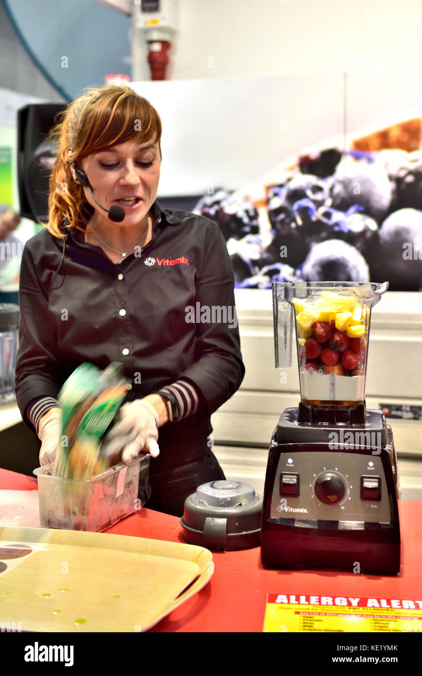 Woman demonstrator demonstrating the Vitamix food blender at Grand Designs show in NEC, Birmingham, UK Stock Photo