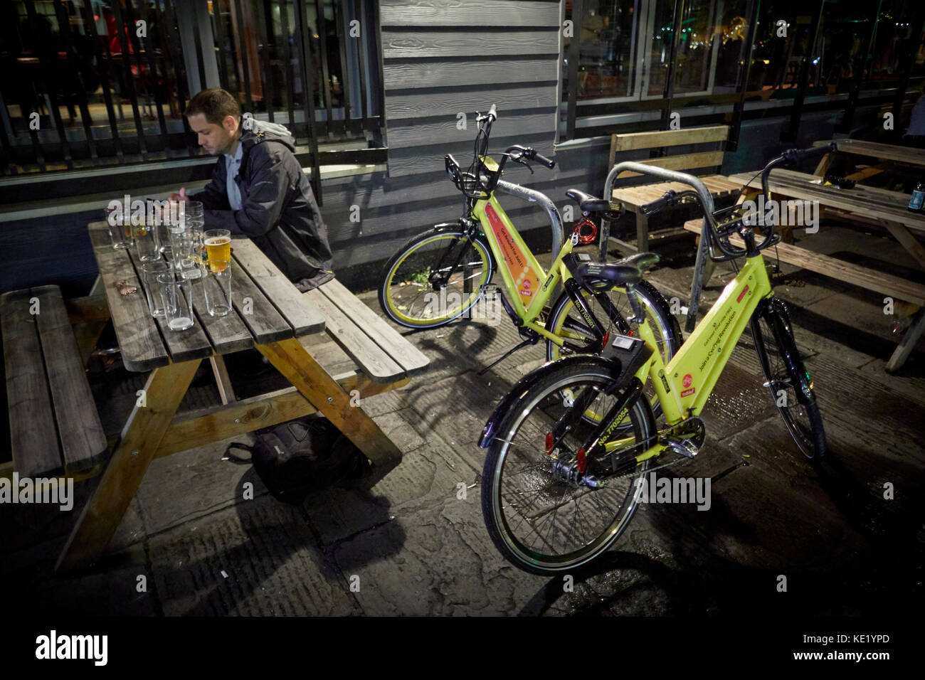 Late night drinking  on King Street Bristol city centre two YoBikes Stock Photo