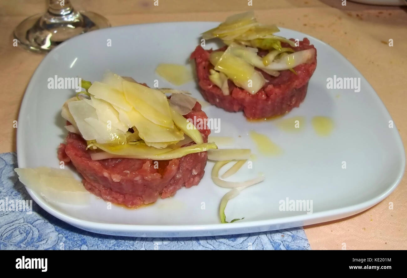Raw meat with parmesan flakes Stock Photo