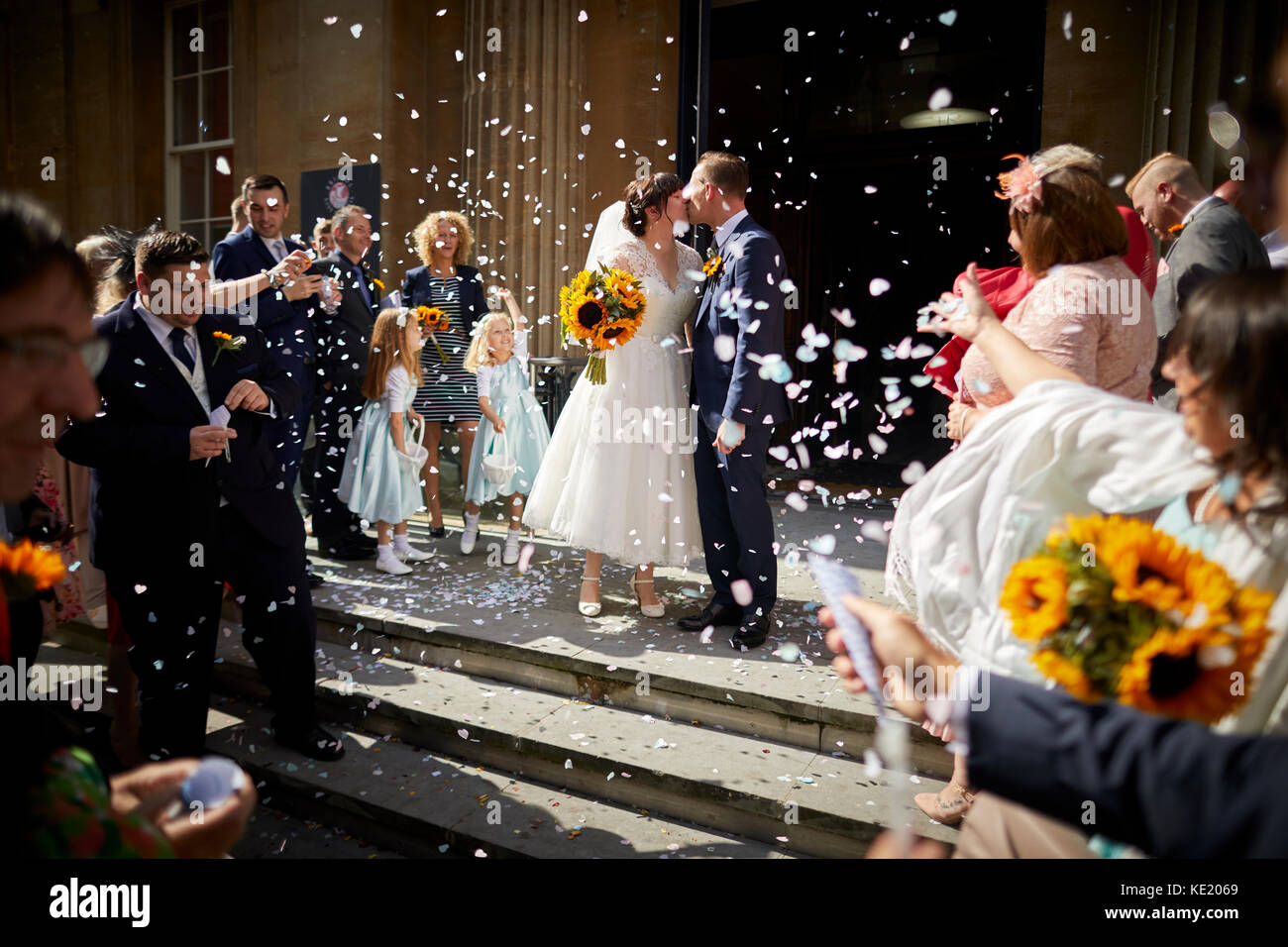 Wedding, crowd guests throwing confetti departing from Corn Street Bristol Register Office Bristol city centre Stock Photo