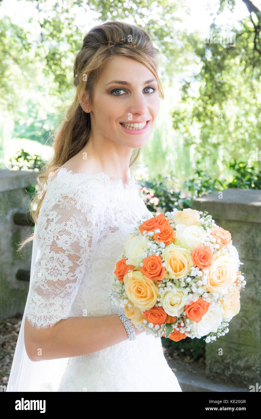Beautiful bride smiling big wedding bouquet Stock Photo - Alamy