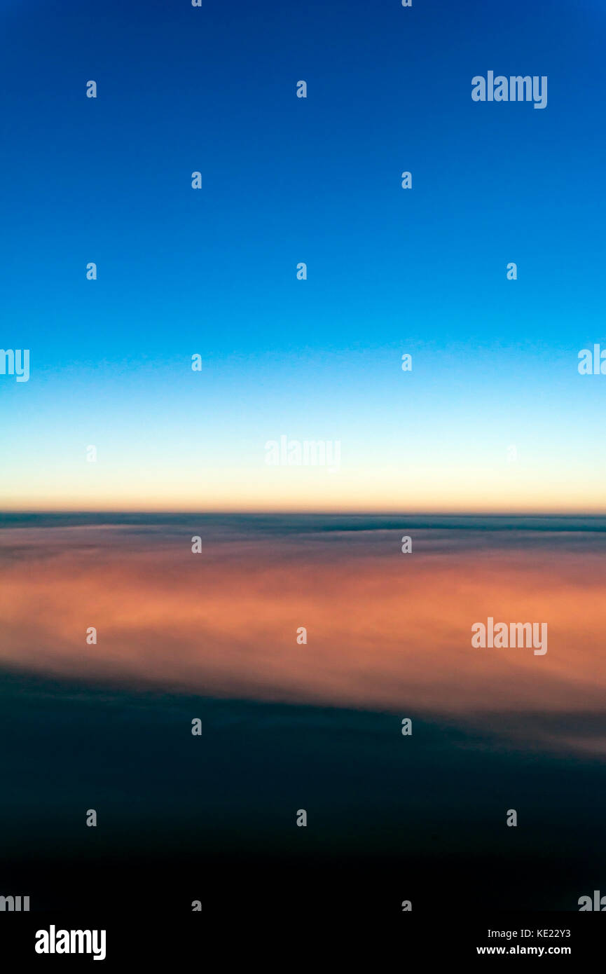 View of the clouds and sky above from the airplane window Stock Photo ...