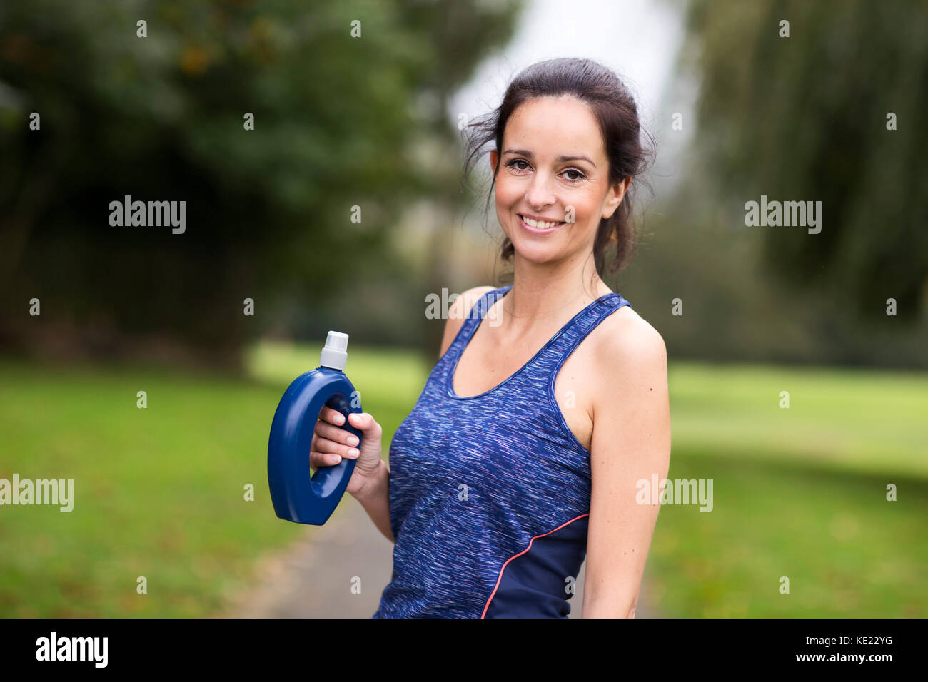 fitness woman holding a water bottle Stock Photo - Alamy