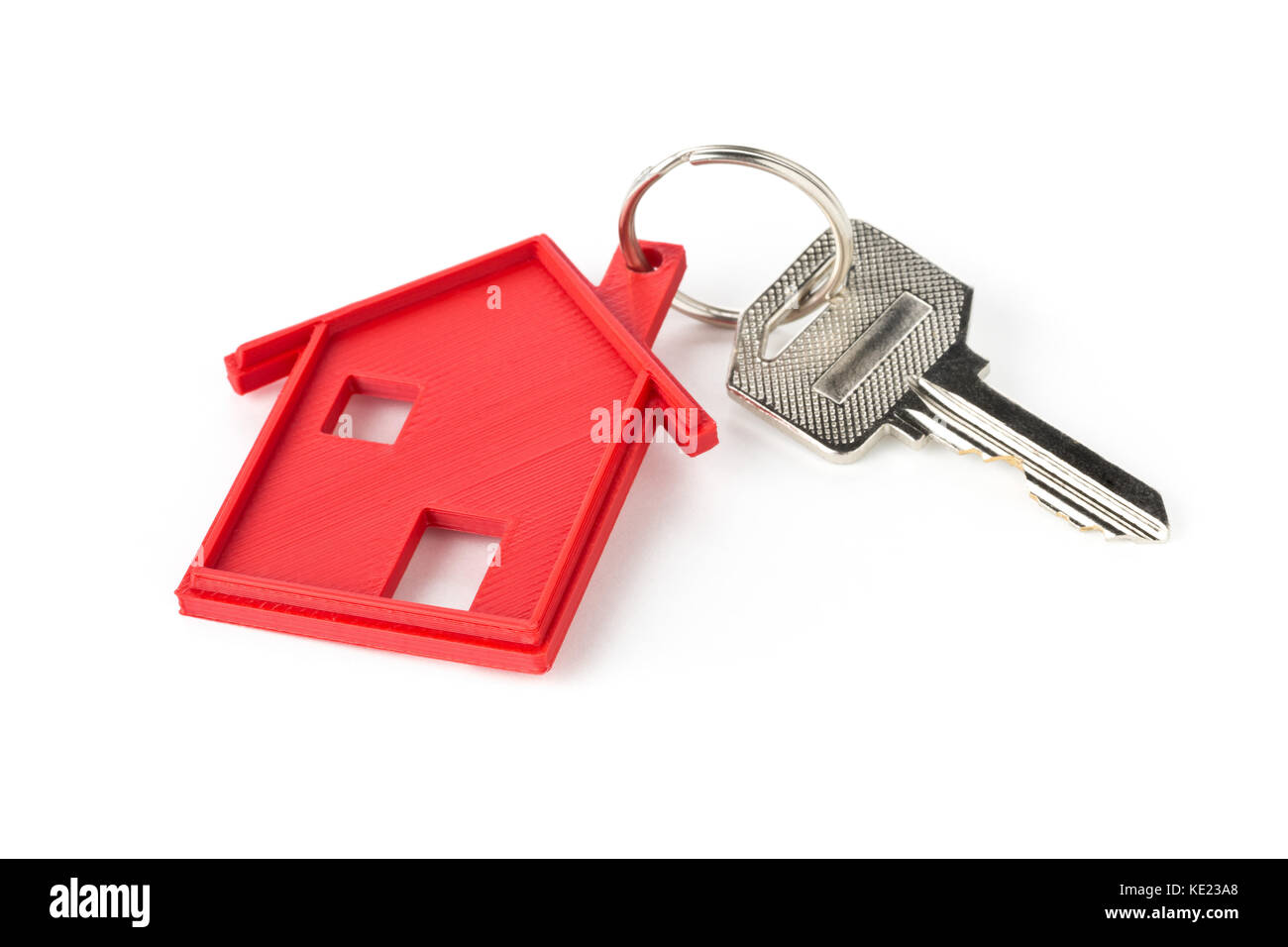 House door key with red house key chain pendant over white background Stock Photo