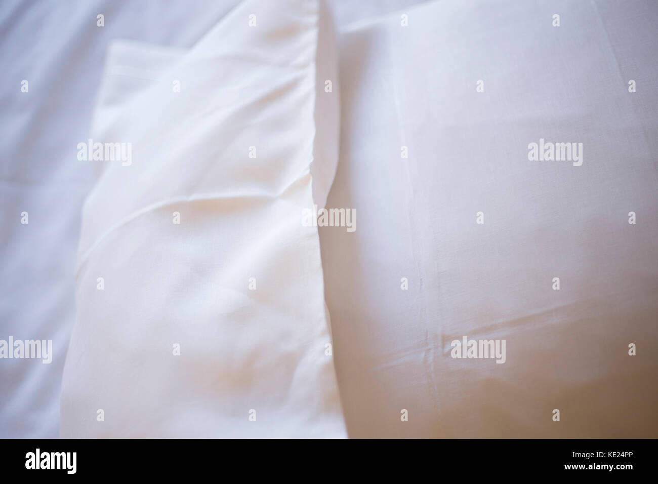 Luxury hotel bedroom bed clean ironed tidy cotton sheets and pillows