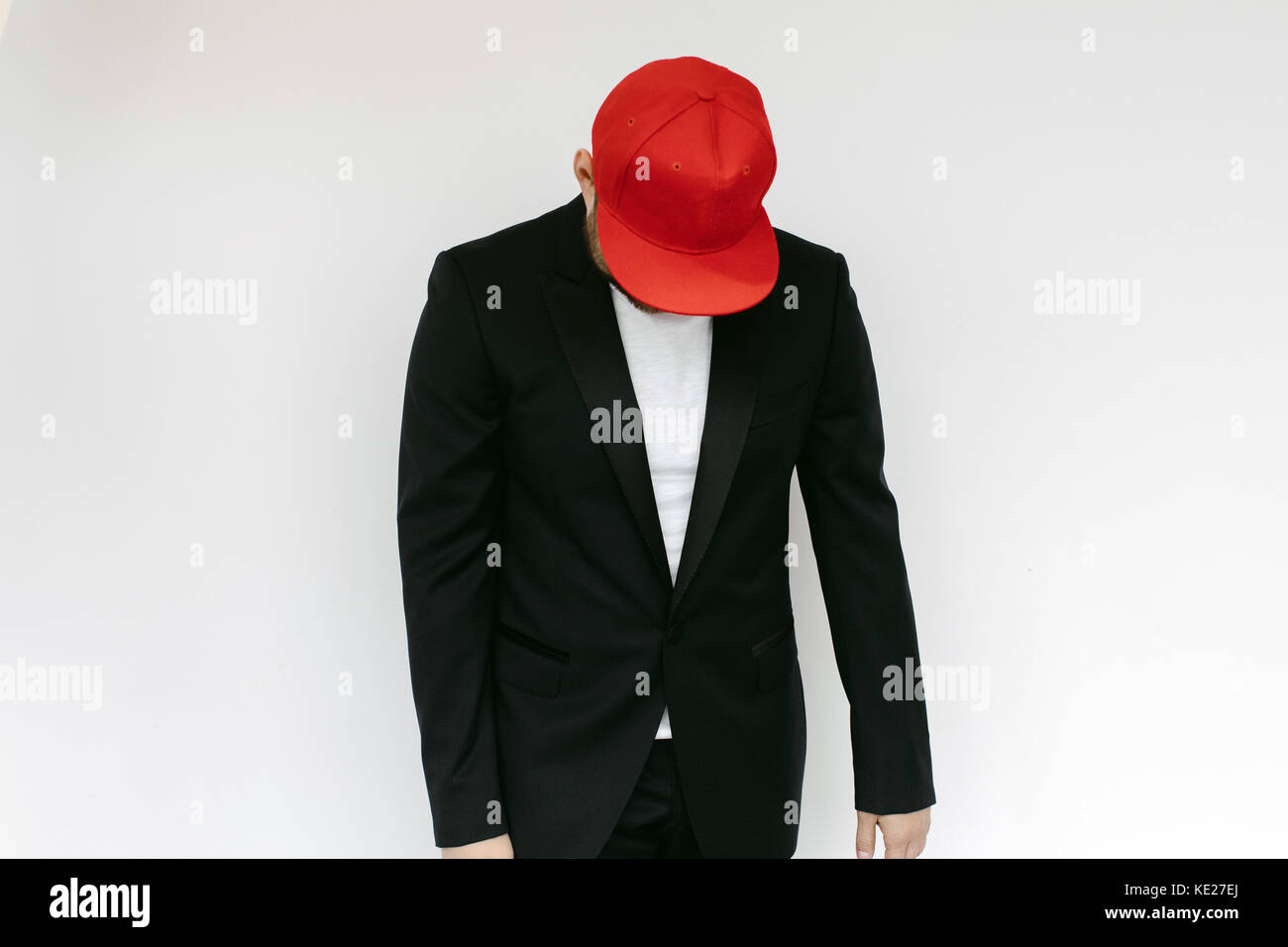 Man in suit and red cap on a white background Stock Photo