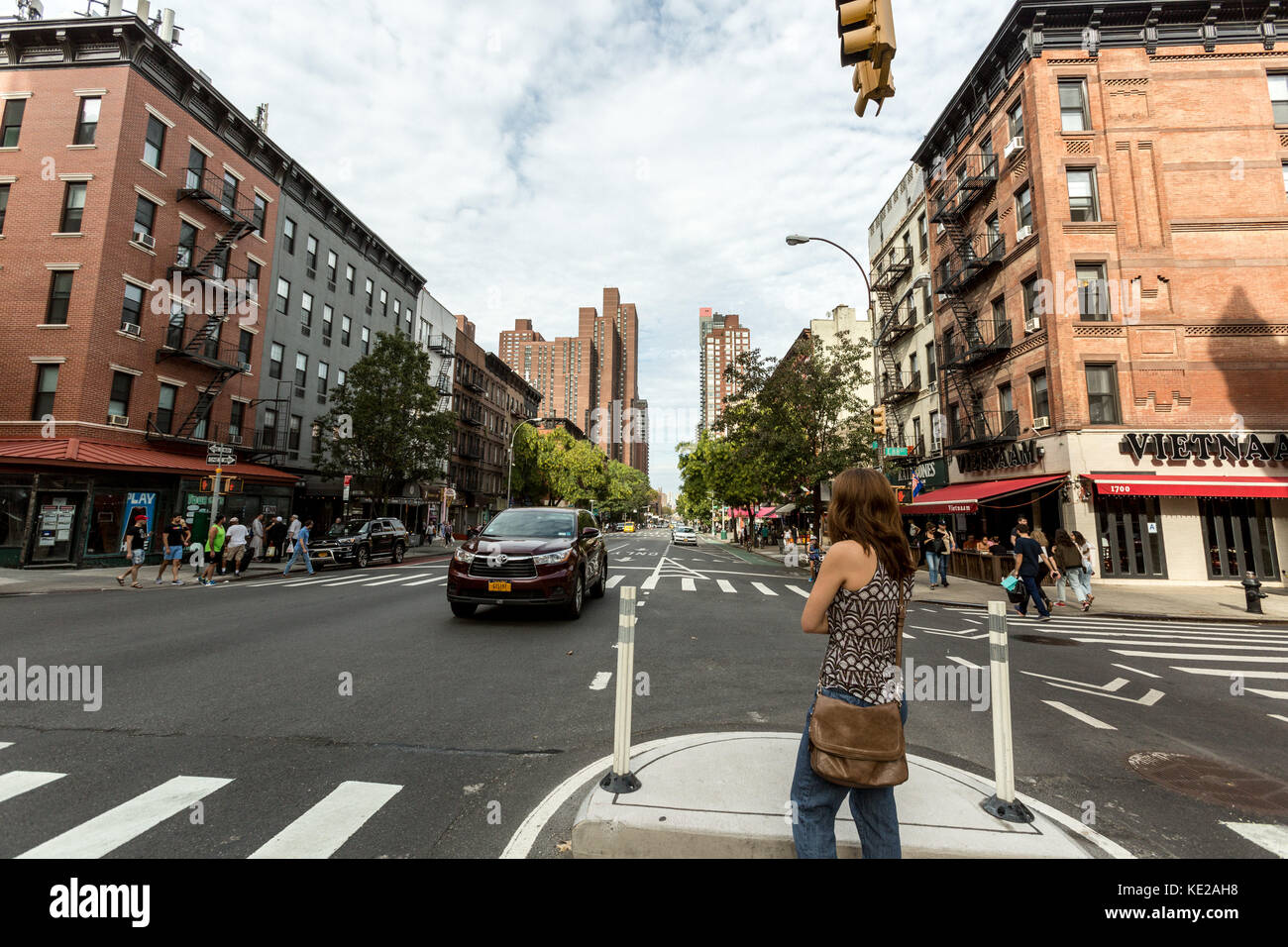 Woman on pedestrian crossing island on 2nd Avenue in the Upper East Side of Manhattan, NY. Stock Photo