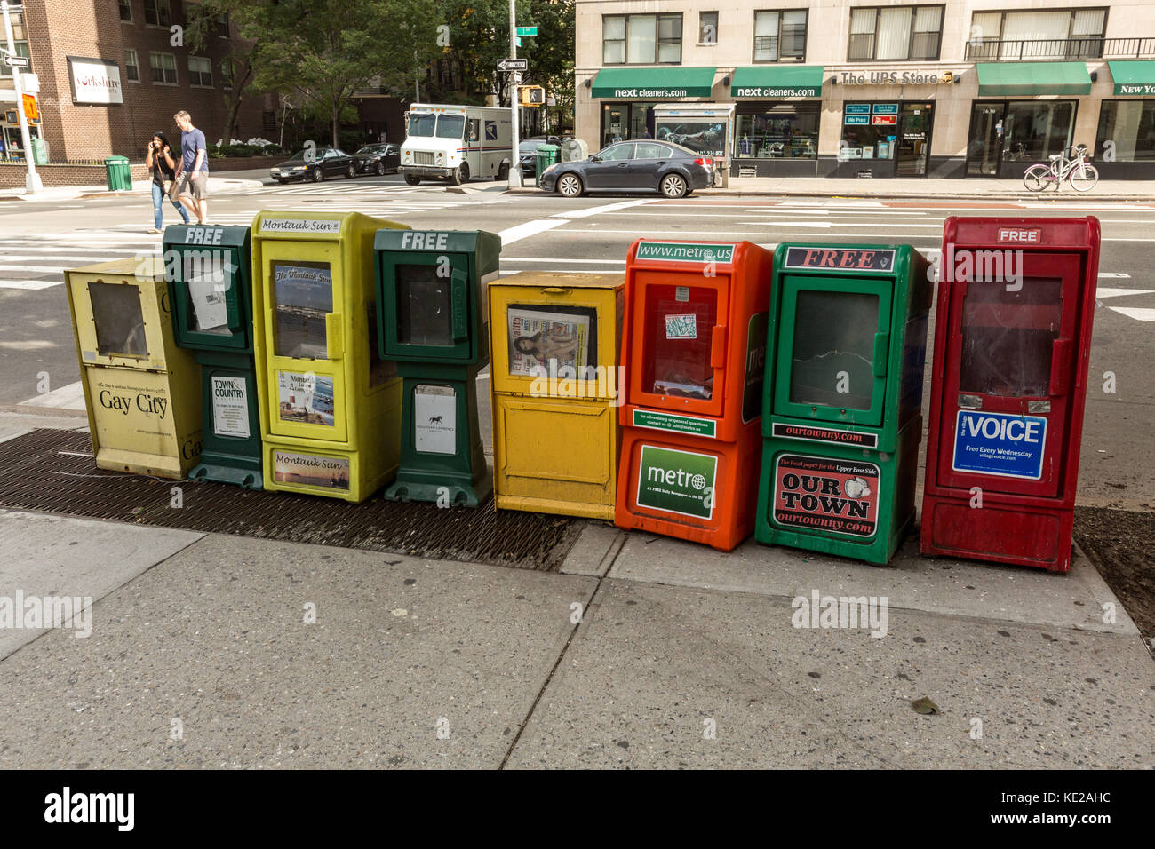 Row of free newspaper dispensers on the Upper East Side of Manhattan, NY. Stock Photo