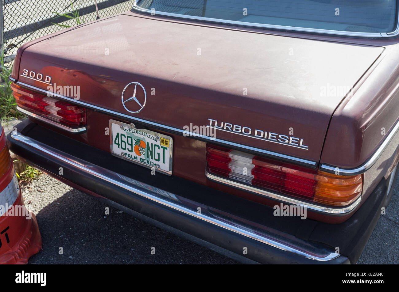 Back of maroon coloured classic Mercedes Benz car with Florida licence plate on street in Hunters Point, Queens, New York City. Stock Photo