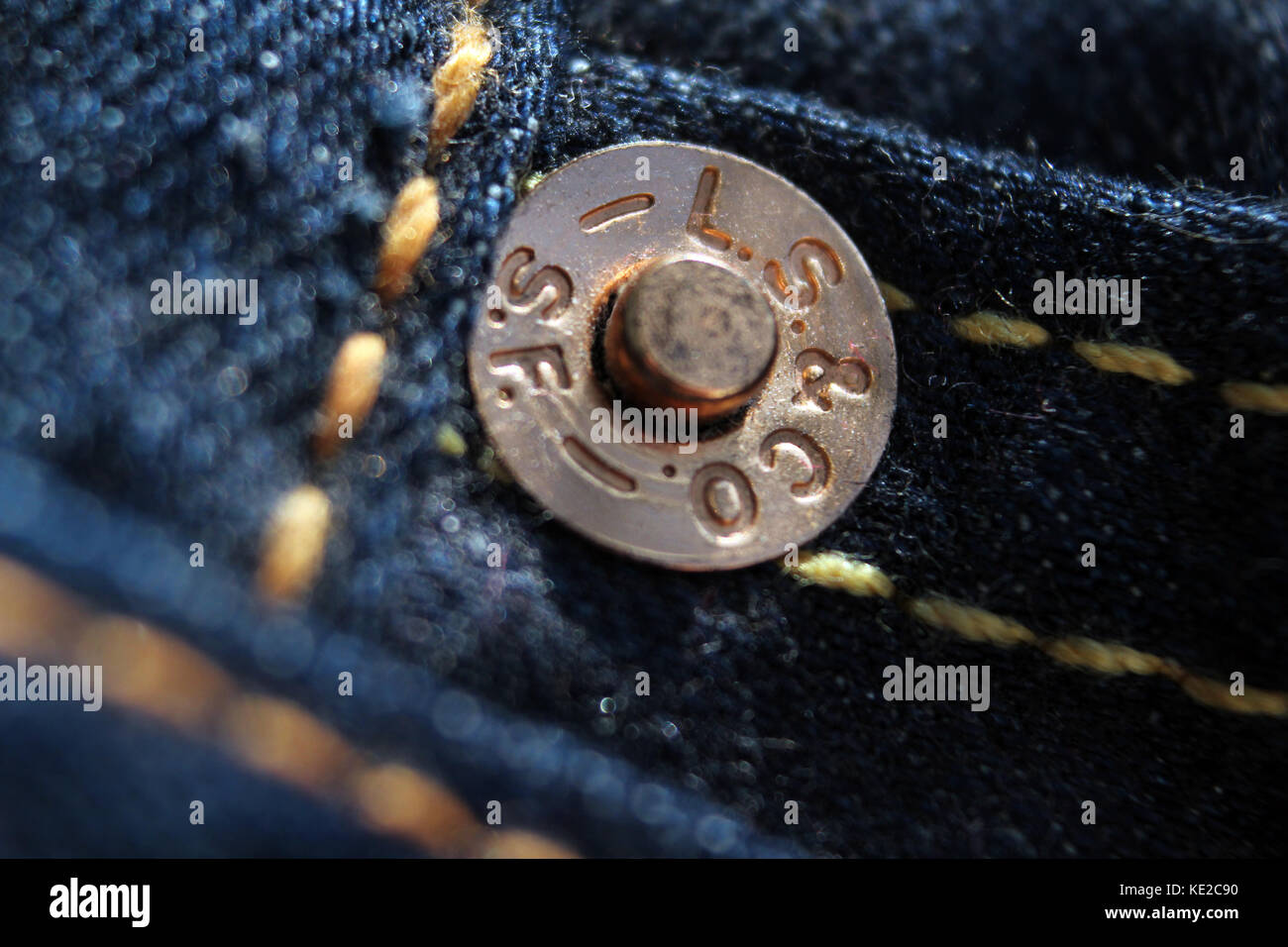 Macro closeup of button reading "Levi Strauss & Co SF Cal" on a pair