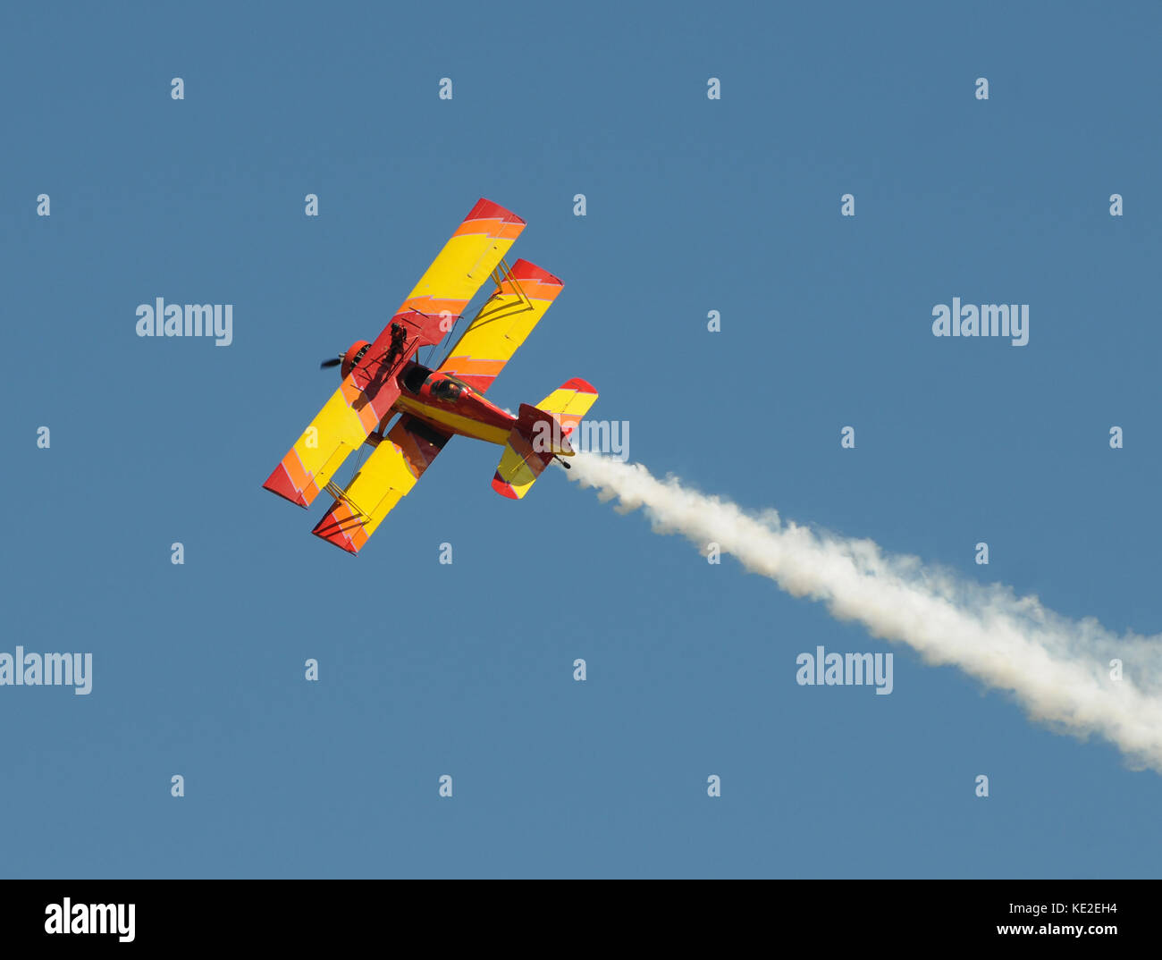 Retro yellow wiplane soaring into the sky stock photo alamy