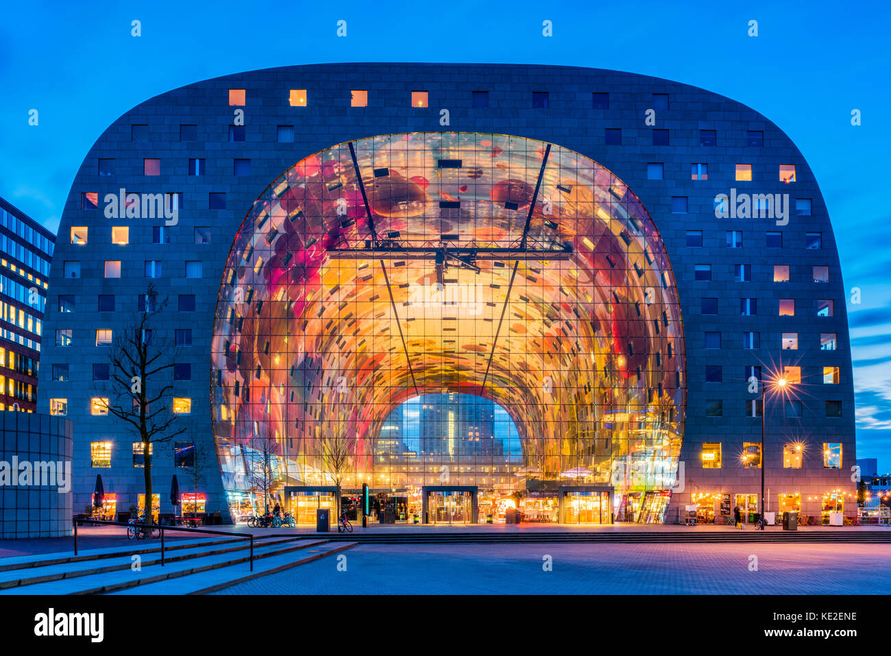 Market Hall in the Blaak district of Rotterdam, Netherlands at dusk. It is a residential and office building with a market hall underneath. Stock Photo