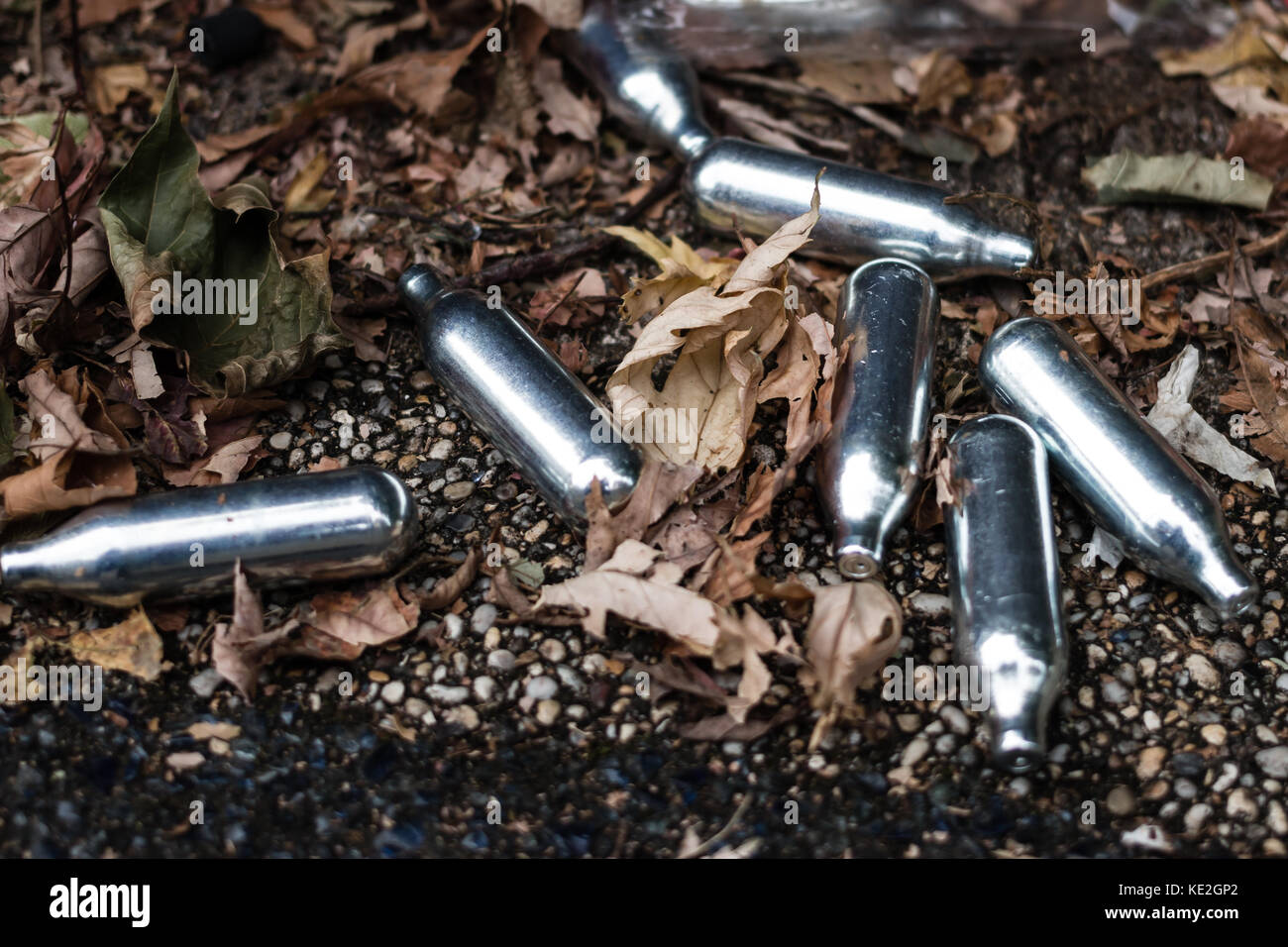 Discarded nitrous oxide canisters on the streets of Bristol Stock Photo