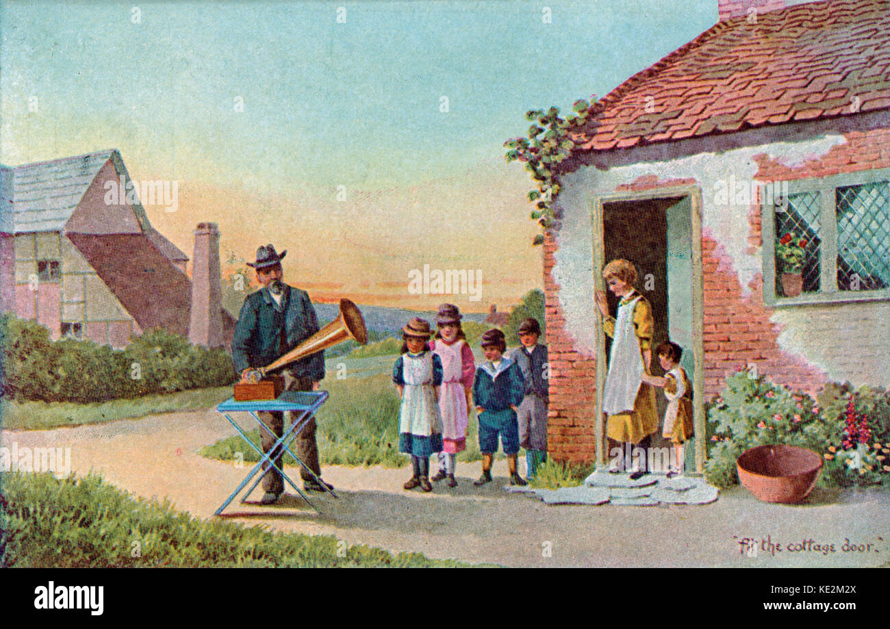 Gramophone - family listening to gramophone recording outside their cottage. Phonograph Stock Photo