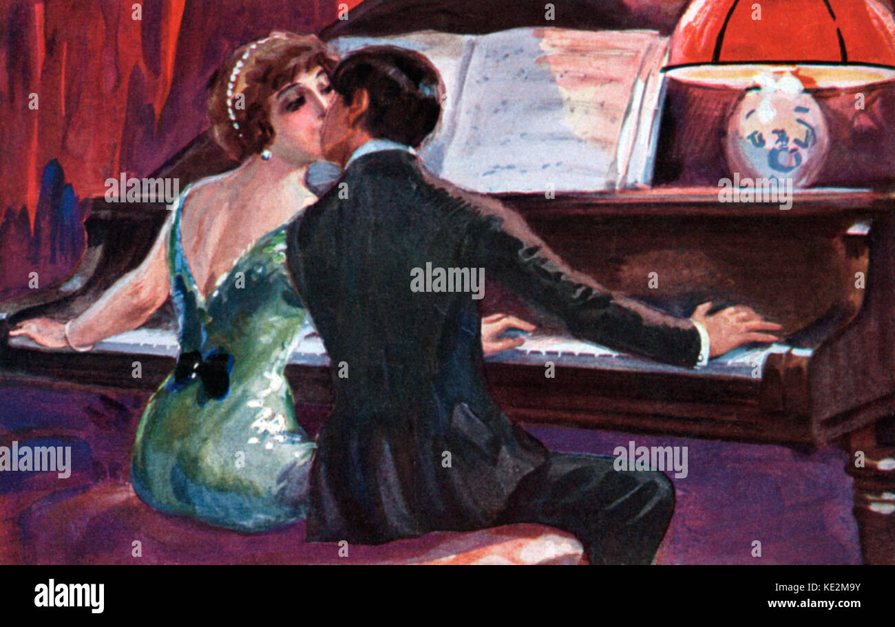 Couple playing a piano duet, kissing behind the keyboard.  Twenties fahion, embrace, embracing. postcard. Stock Photo