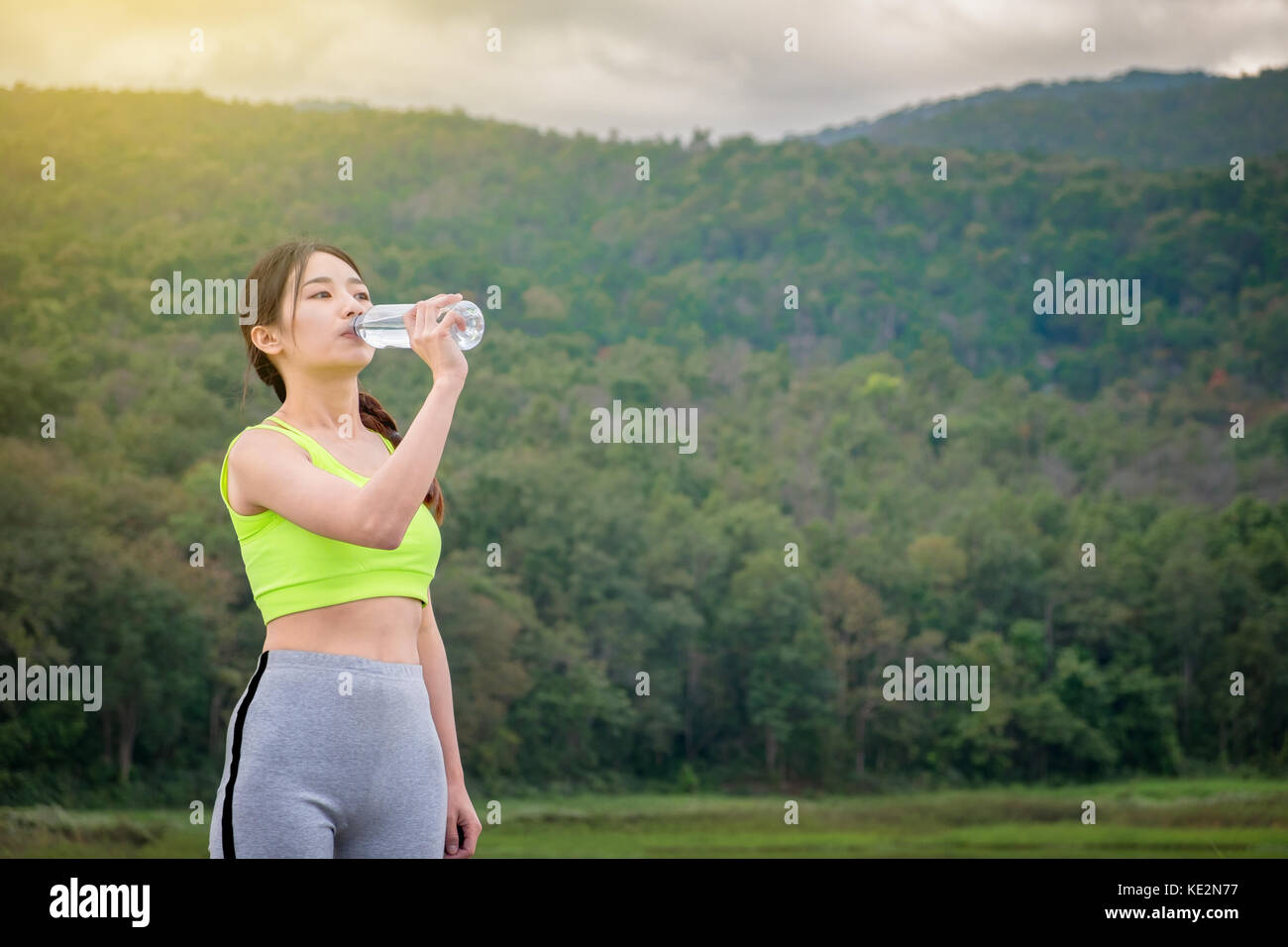 Sport and Health Lifestyle, Beautiful Young Woman Drinking Water After Training. Stock Photo