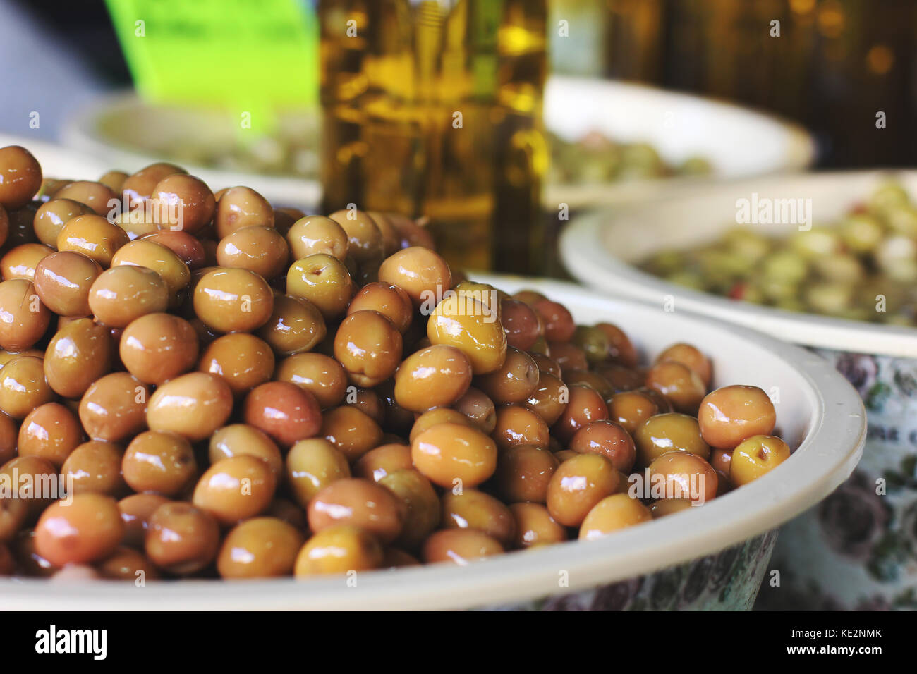 Green pickle olives in bowls and bottles with olive oil at the eastern market Stock Photo Alamy