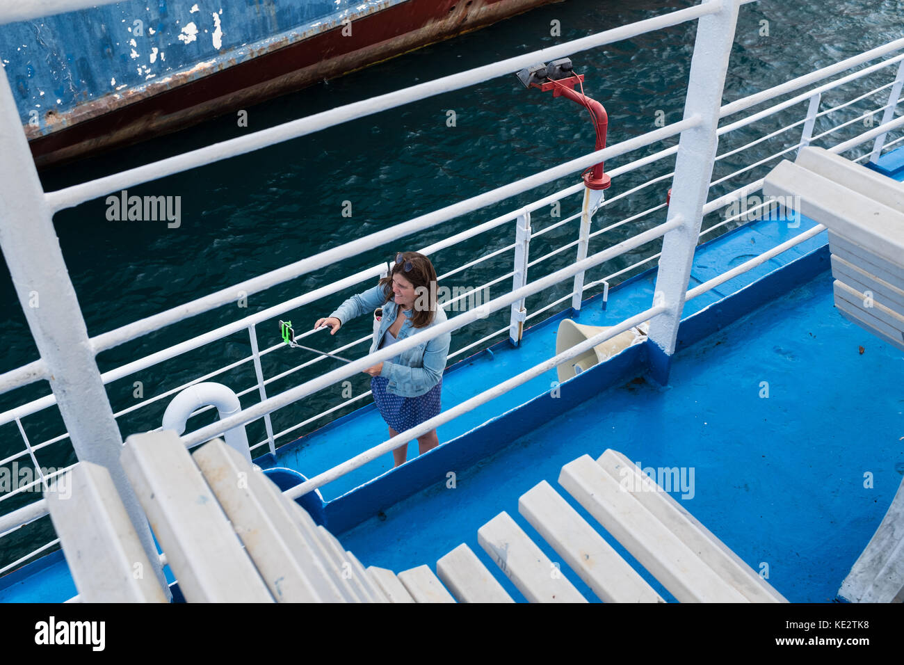Woman taking a selfie photograph on board a ferry Stock Photo