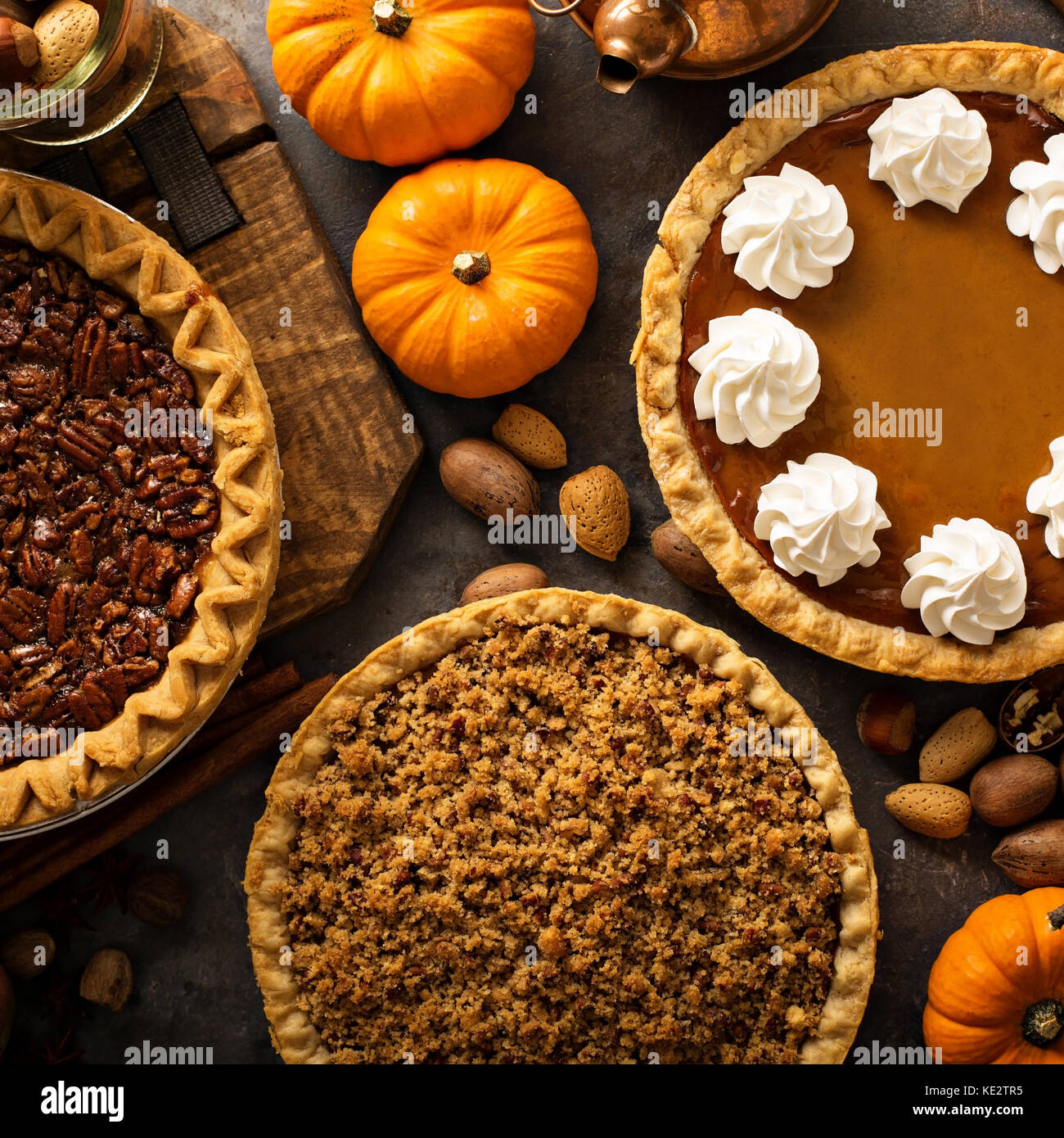 Fall traditional pies pumpkin, pecan and apple crumble pie overhead