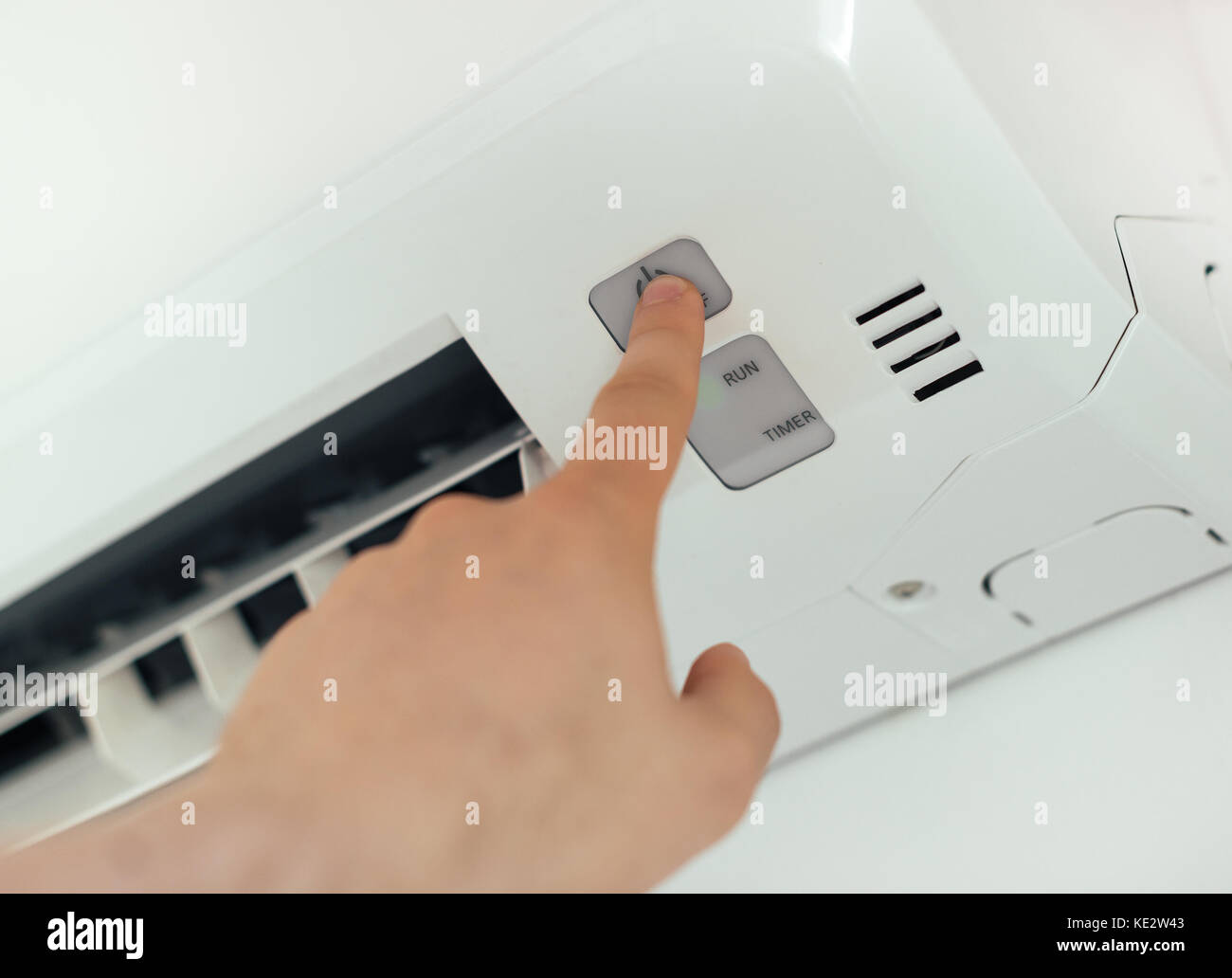 Male hand turns on airconditioning system Stock Photo Alamy