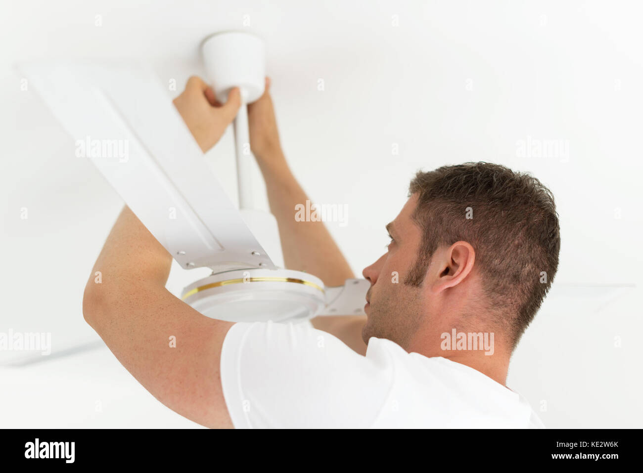 Male technician installing ceiling fan Stock Photo Alamy